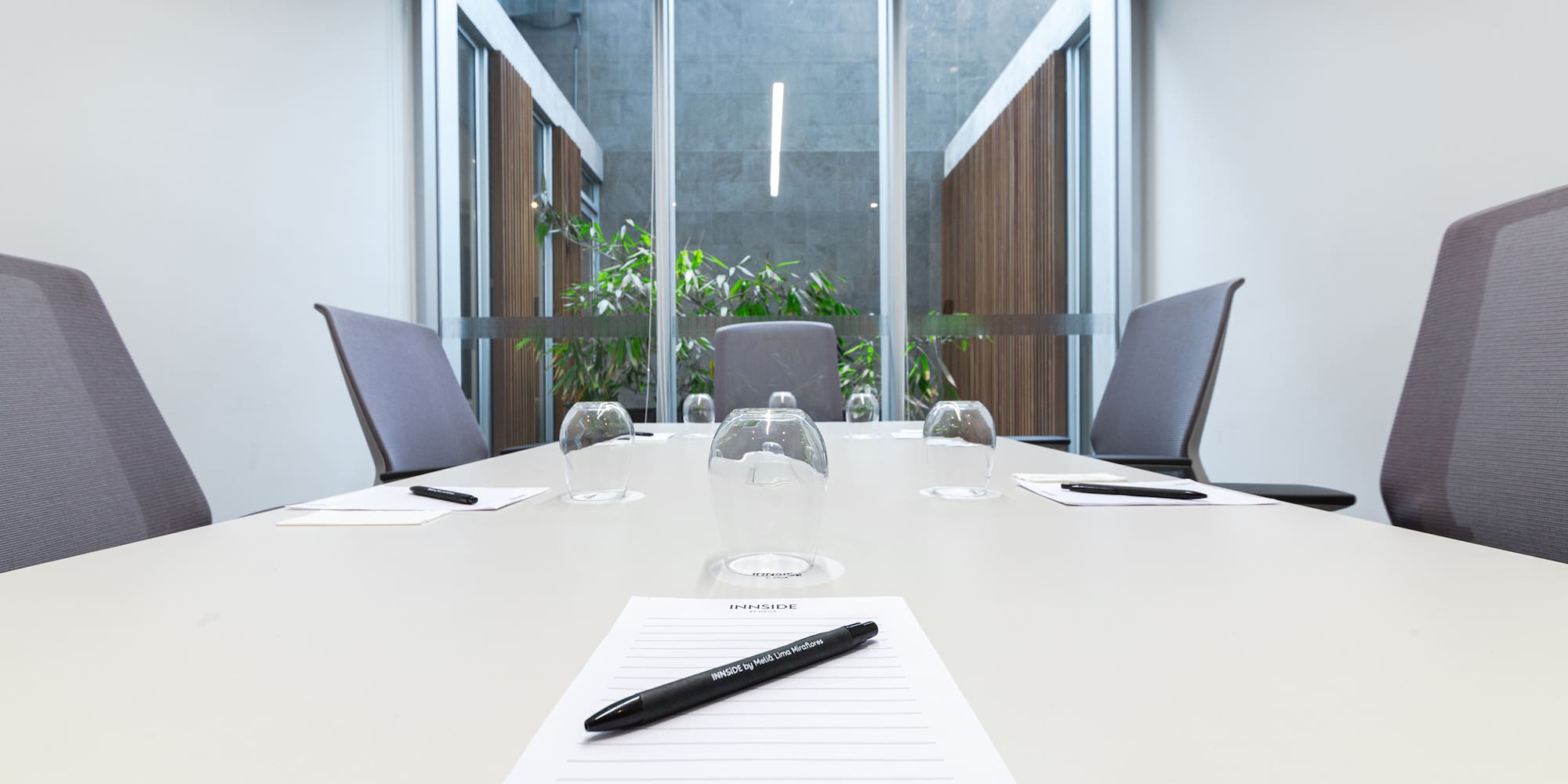 a table with glasses and a pen on it
