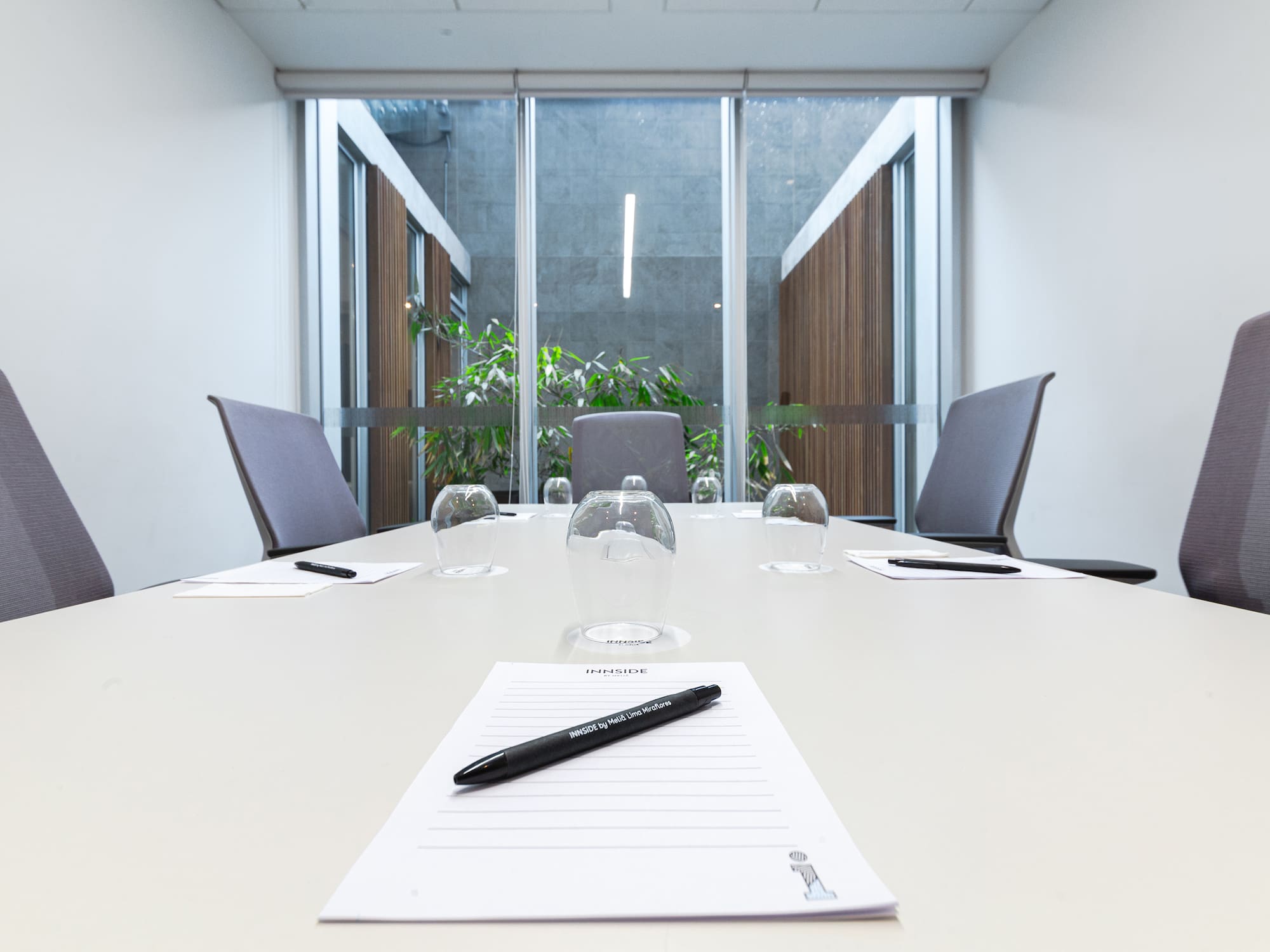 a table with glasses and a pen on it