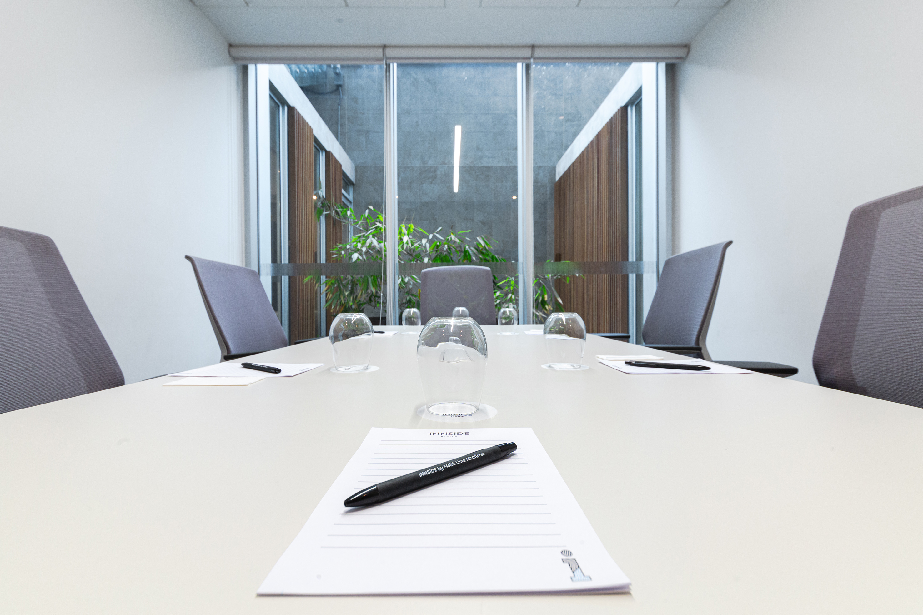 Modern Innside by Meliá meeting room. Table, chairs, notepads, courtyard view.