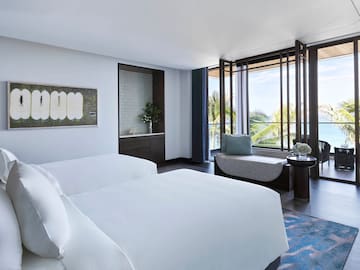 a room with two beds and a couch