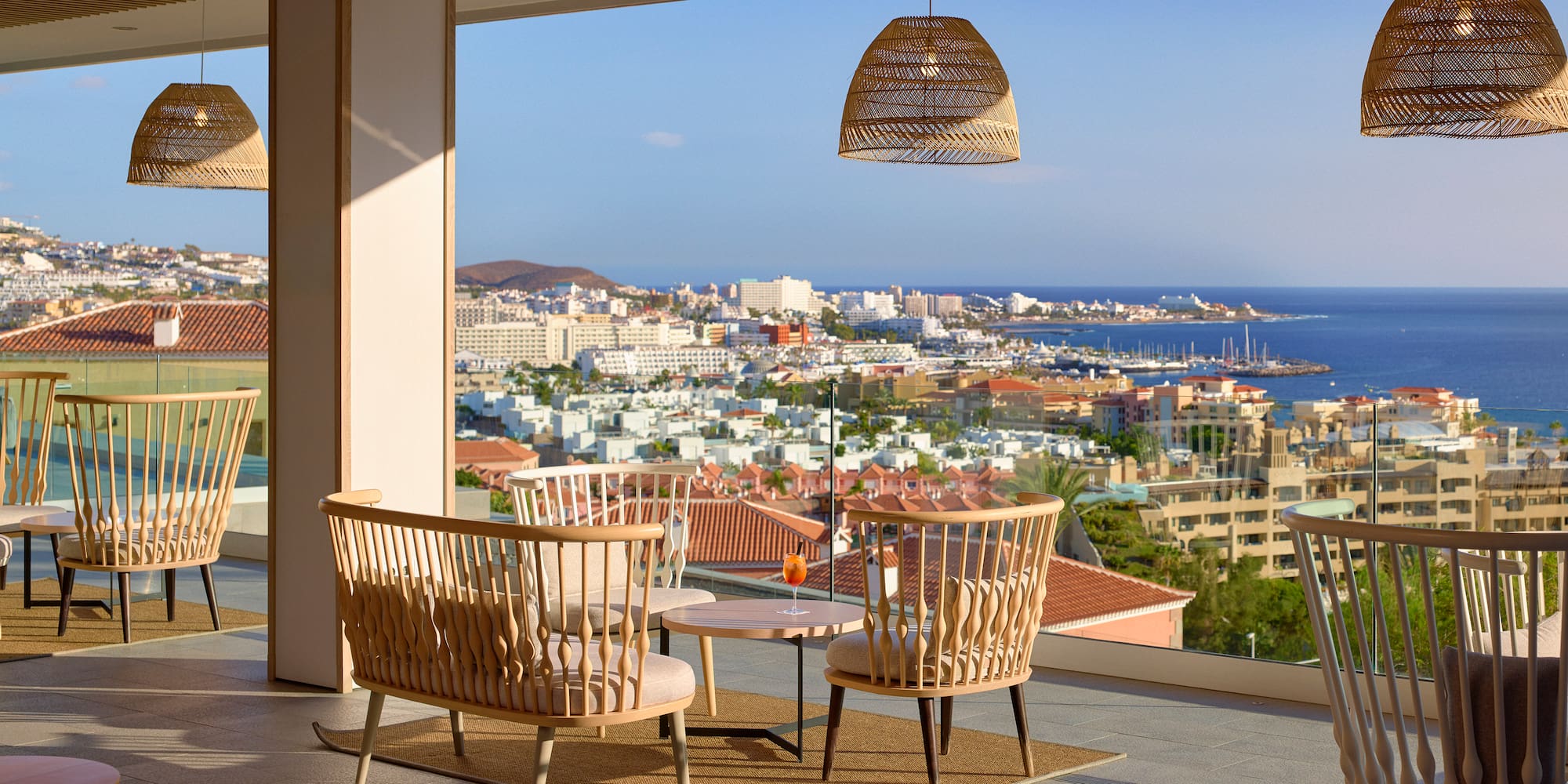 a room with chairs and a table and a view of the city