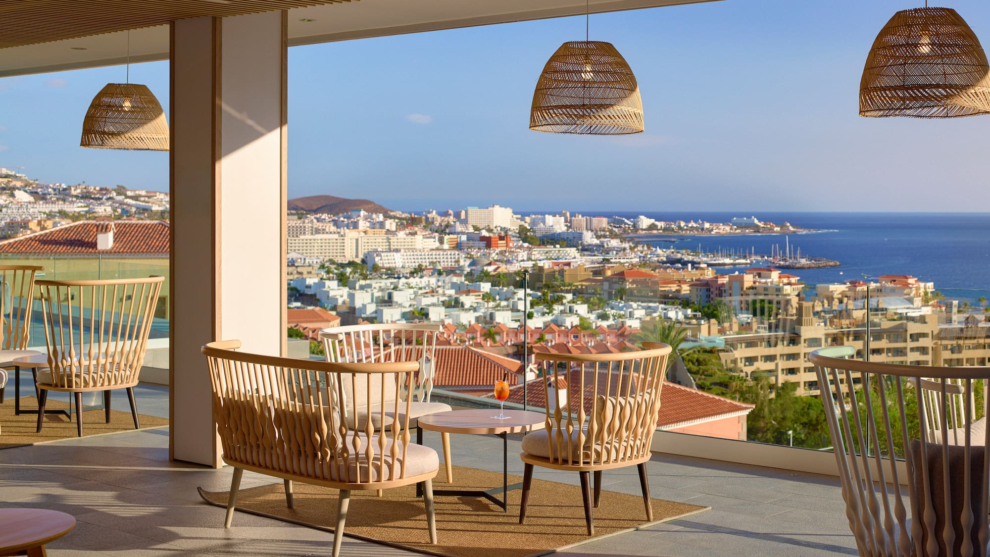 a room with chairs and a table and a view of the city