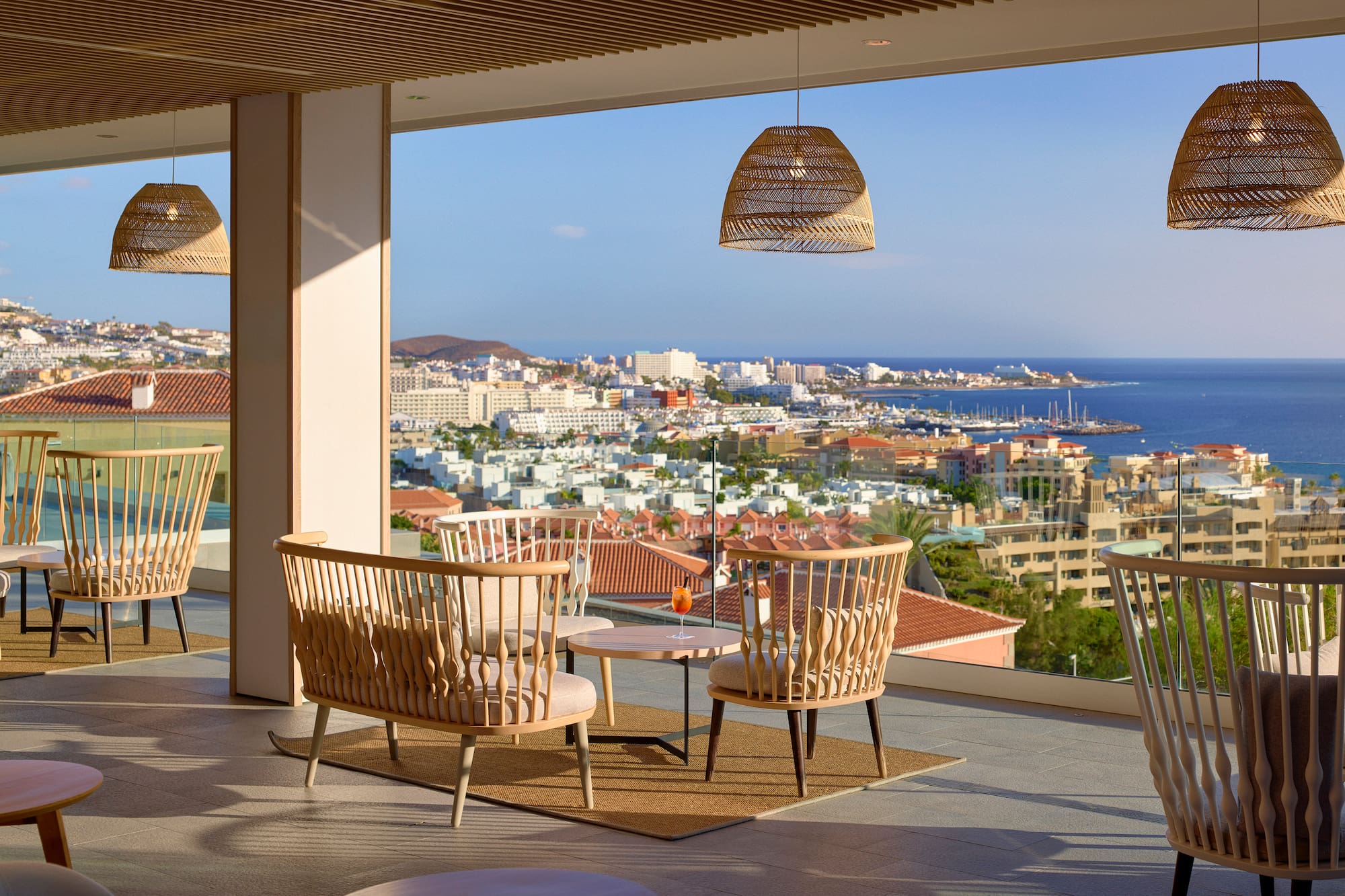 a room with chairs and a table and a view of the city