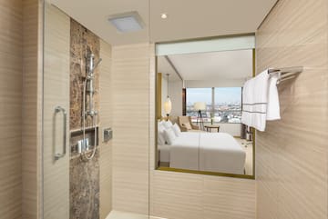 a bathroom with a mirror and a bed