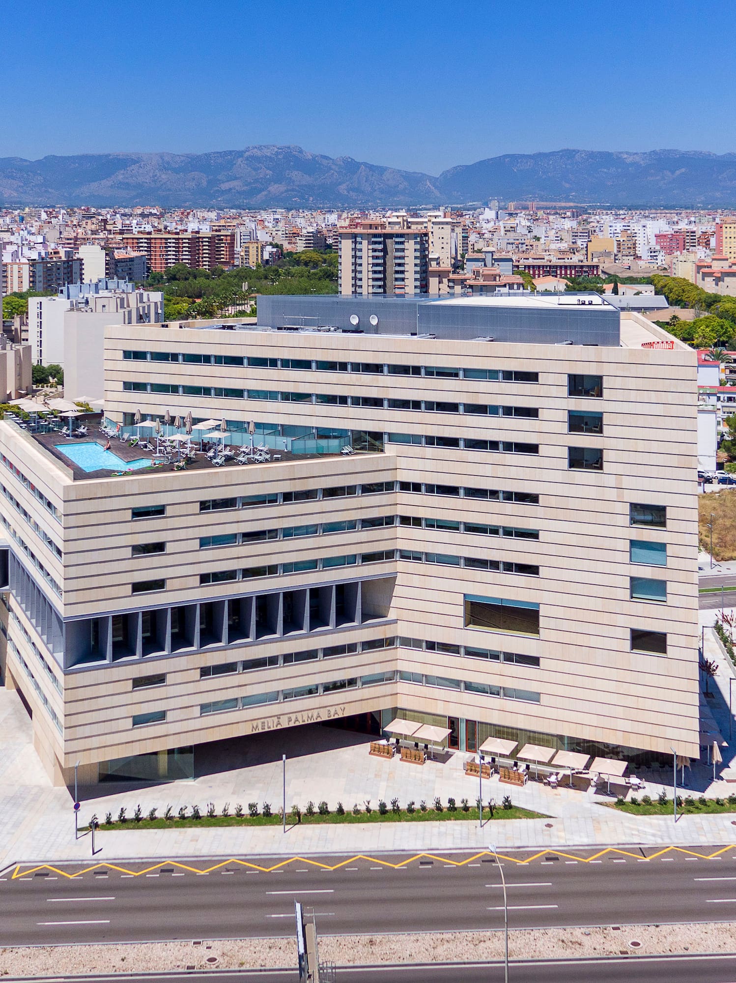 a large building with a parking lot and a road