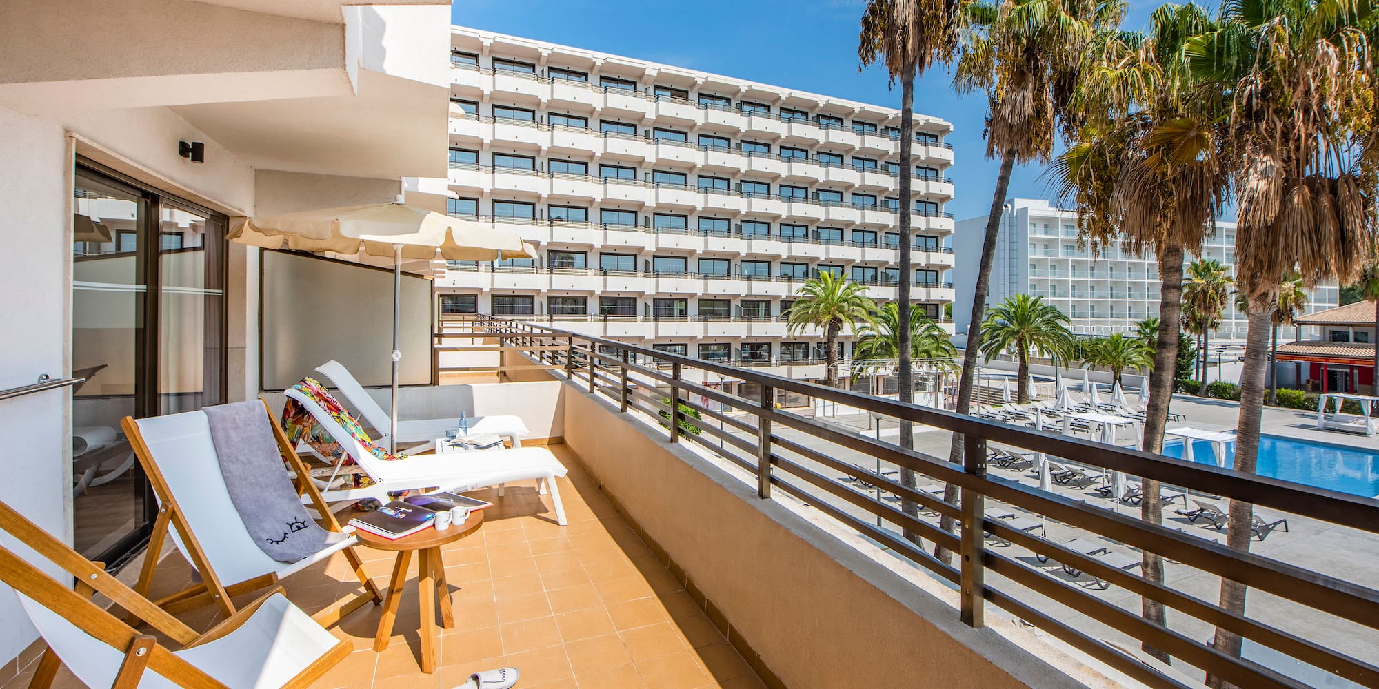 a deck with chairs and palm trees