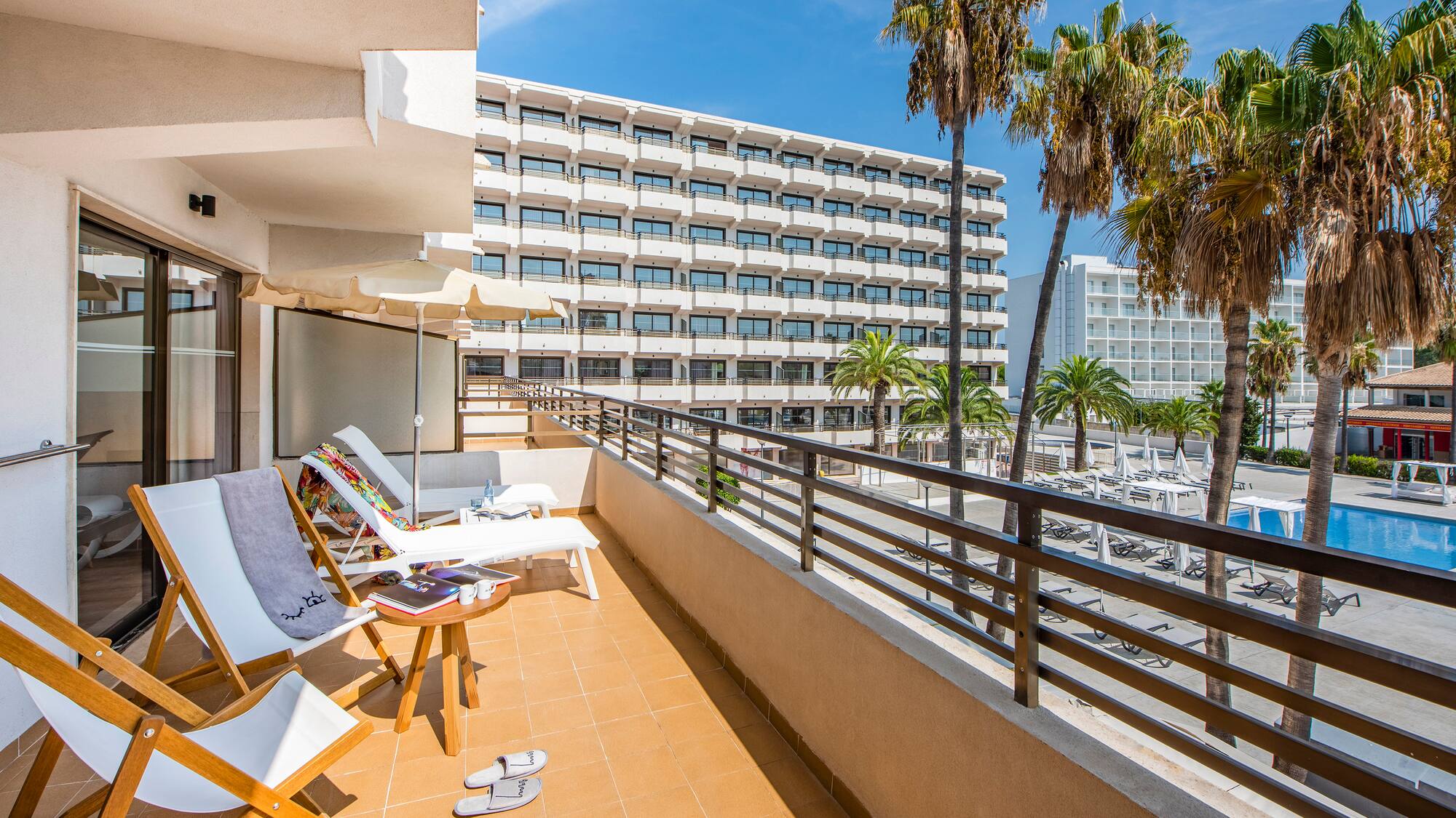 a deck with chairs and palm trees