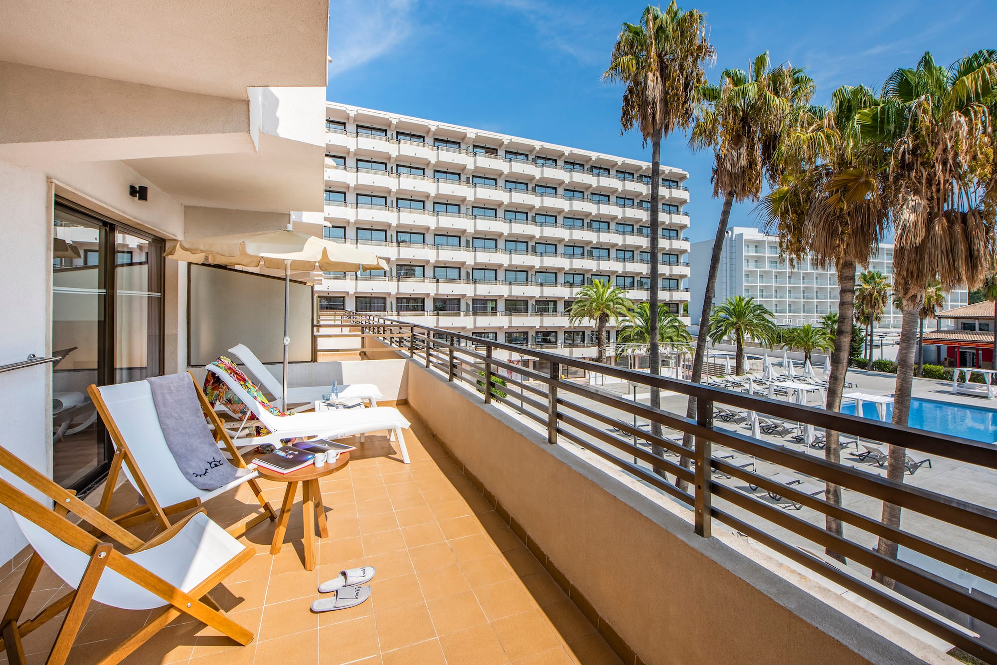a deck with chairs and palm trees