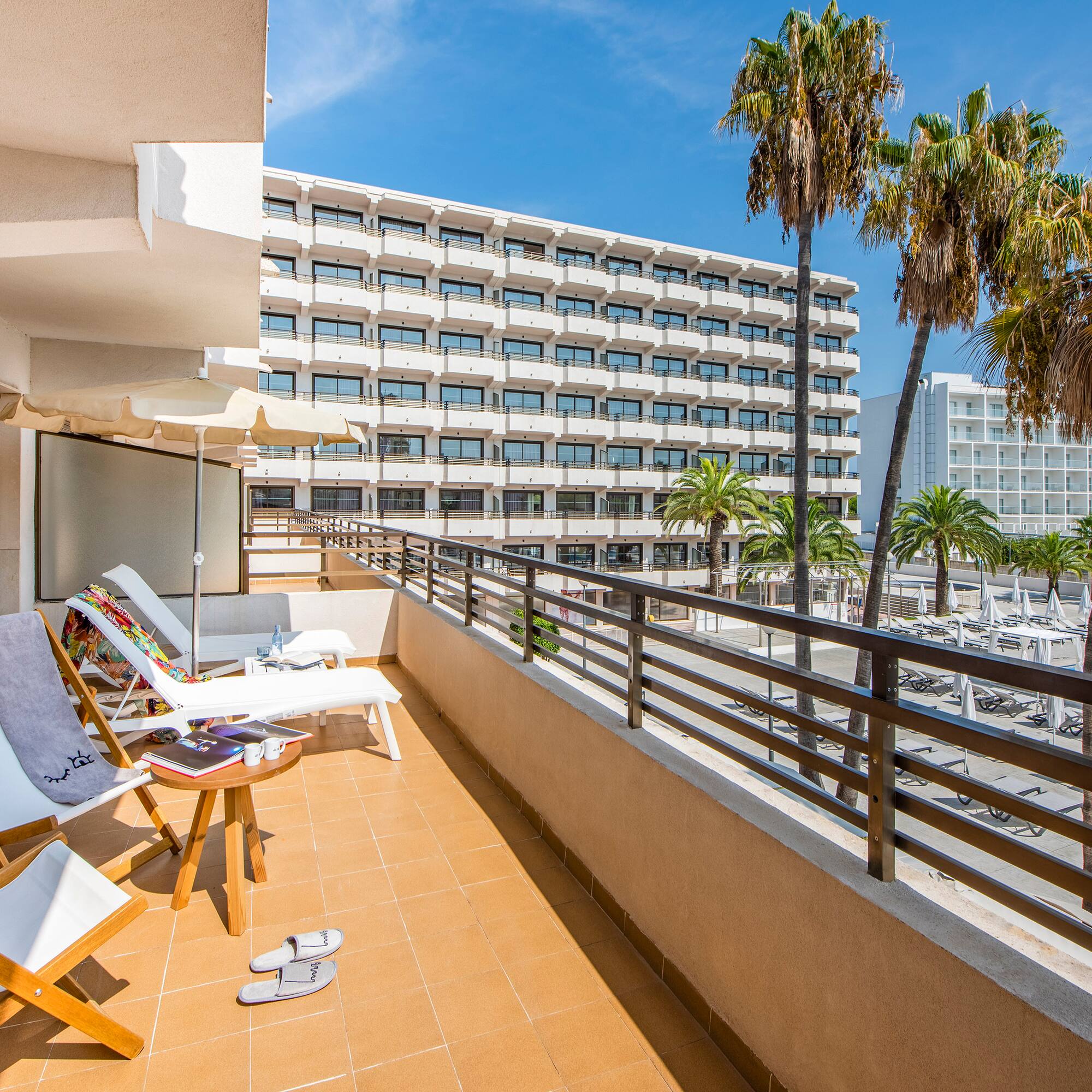 a deck with chairs and palm trees