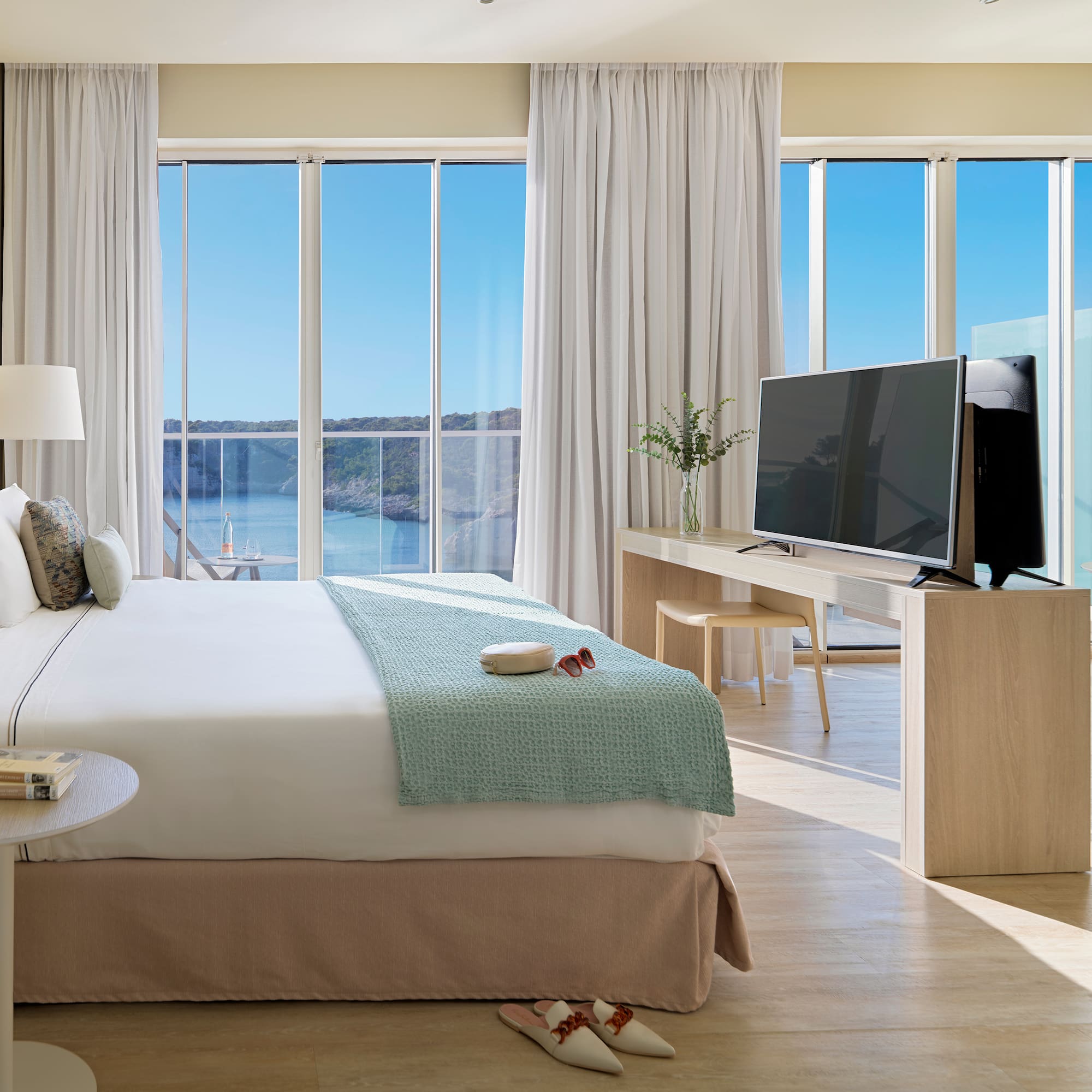 a bedroom with a television and a large window