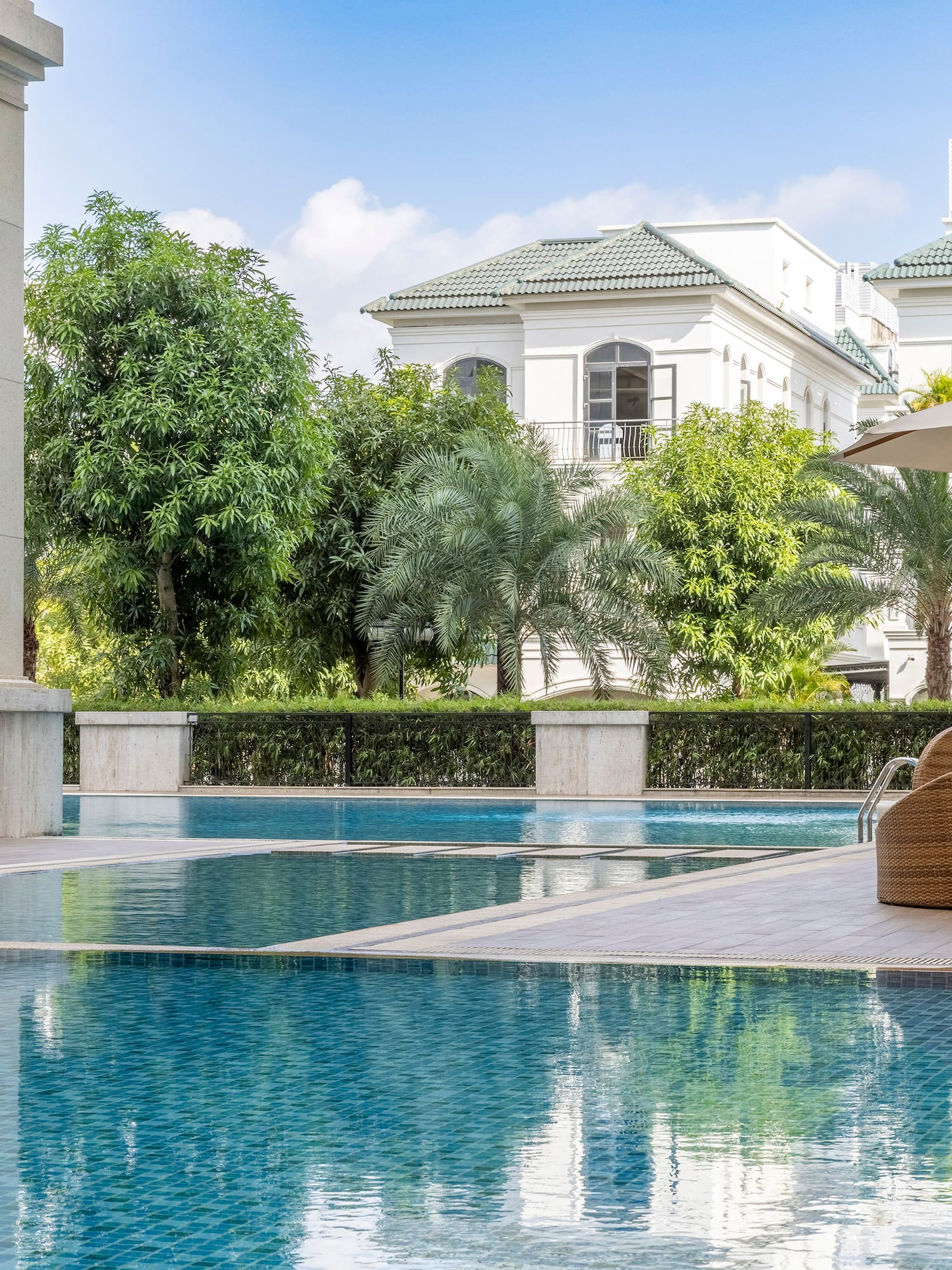 a swimming pool with a chair and umbrellas