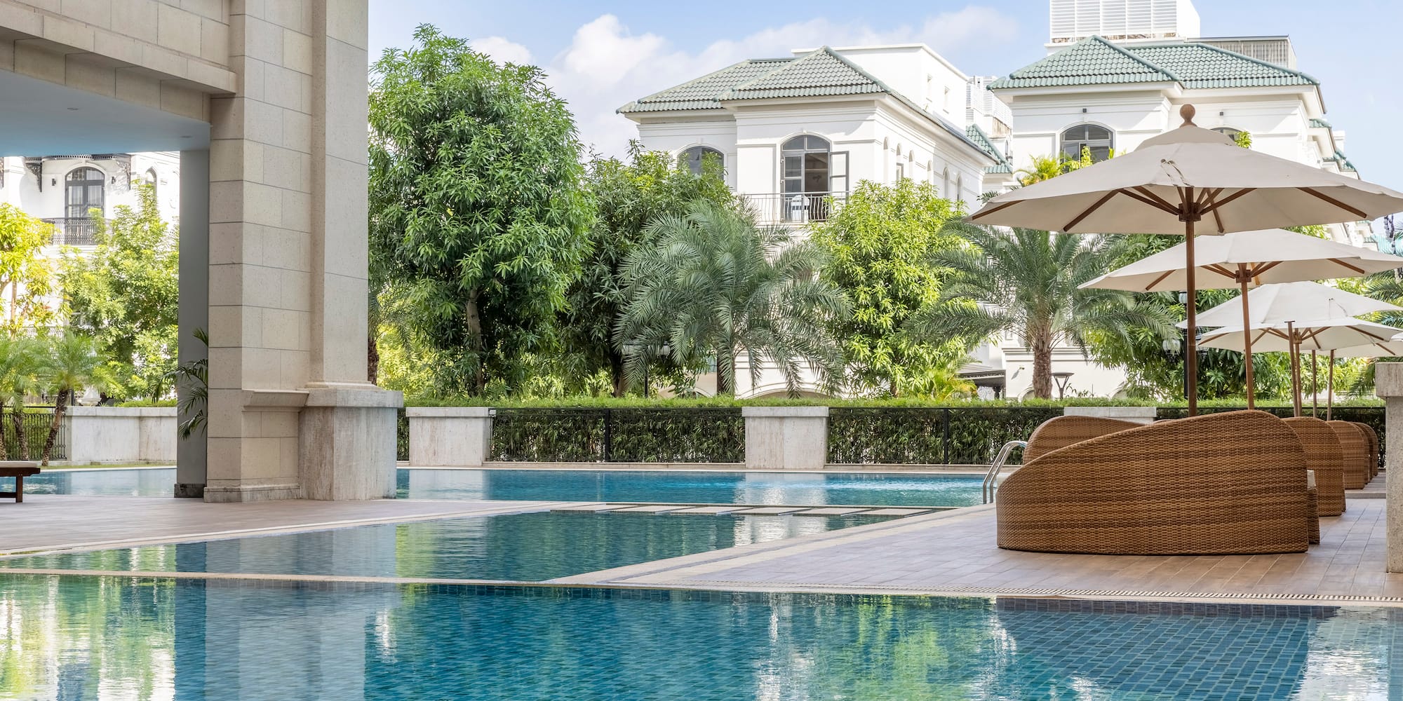 a swimming pool with a chair and umbrellas