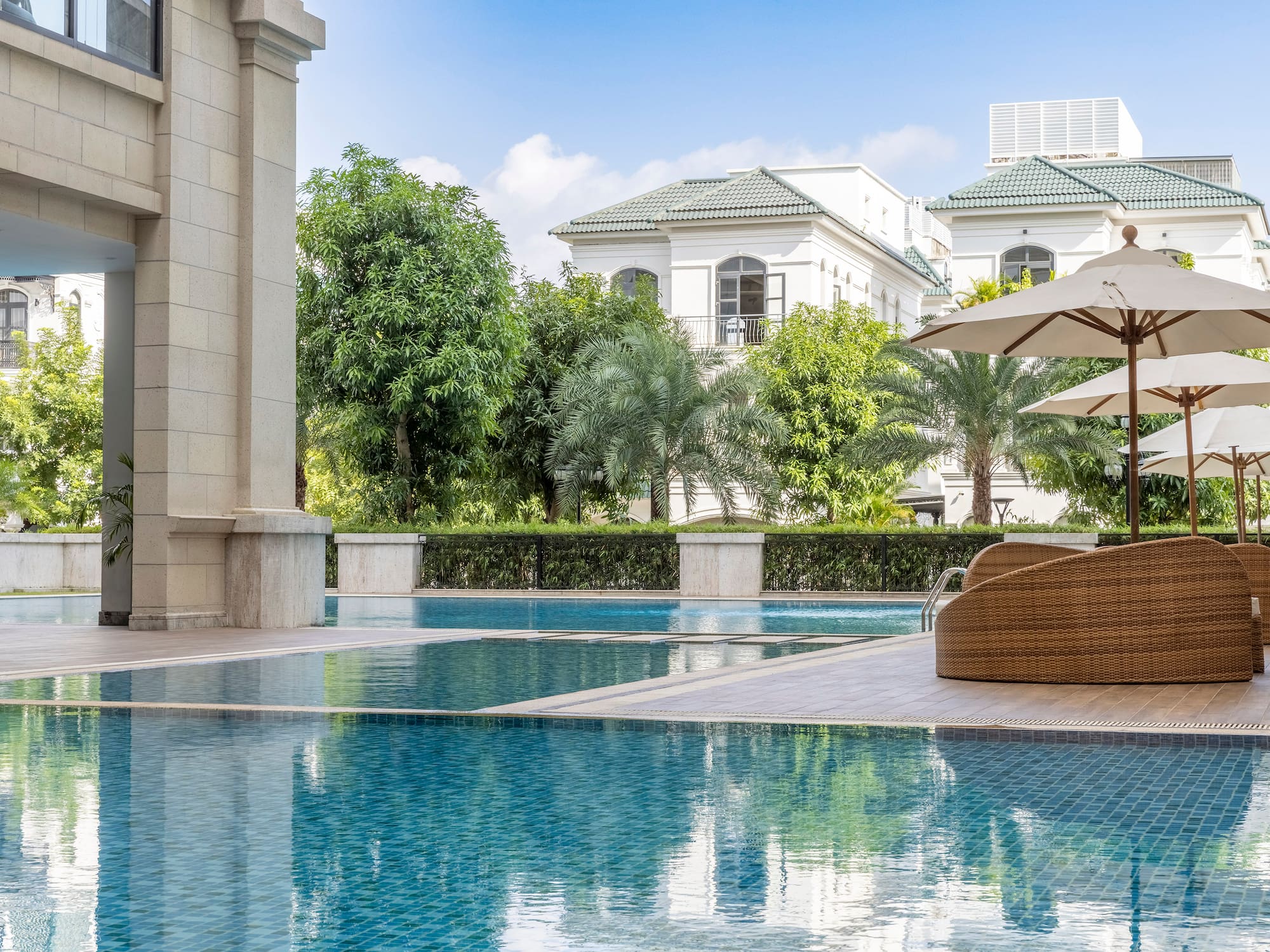 a swimming pool with a chair and umbrellas