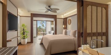 a bedroom with a television and a bed