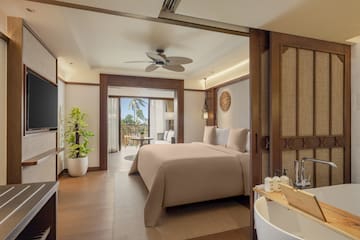 a bedroom with a television and a bed