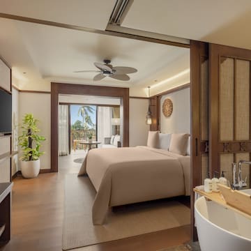 a bedroom with a television and a bed