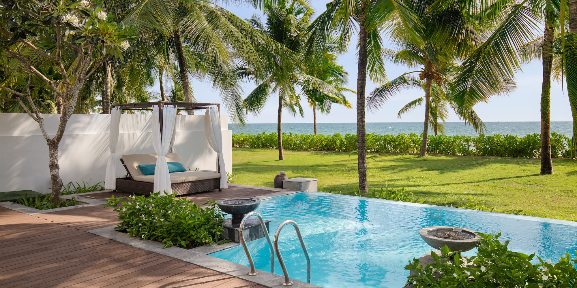 a pool with a deck and palm trees