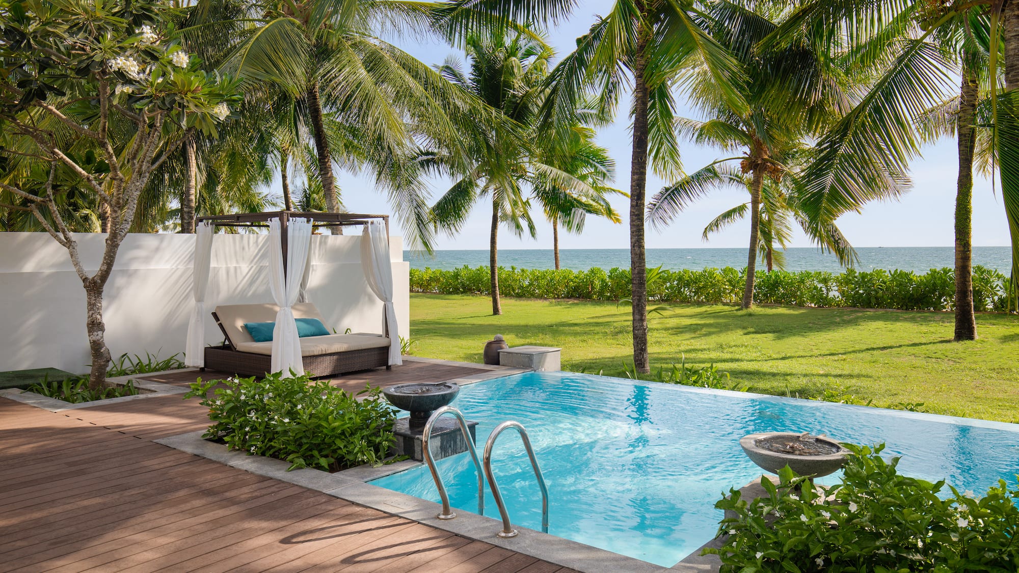 a pool with a deck and palm trees