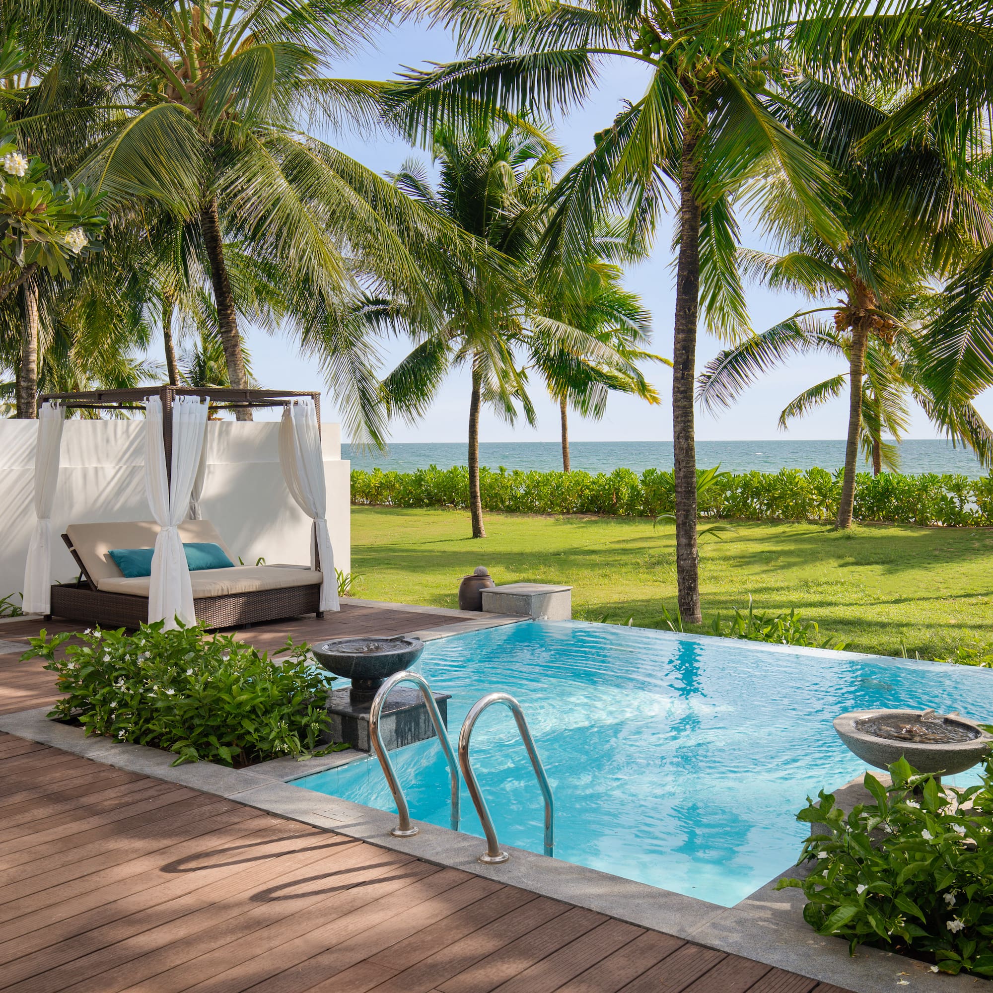 a pool with a deck and palm trees