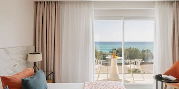 a bedroom with a view of the ocean