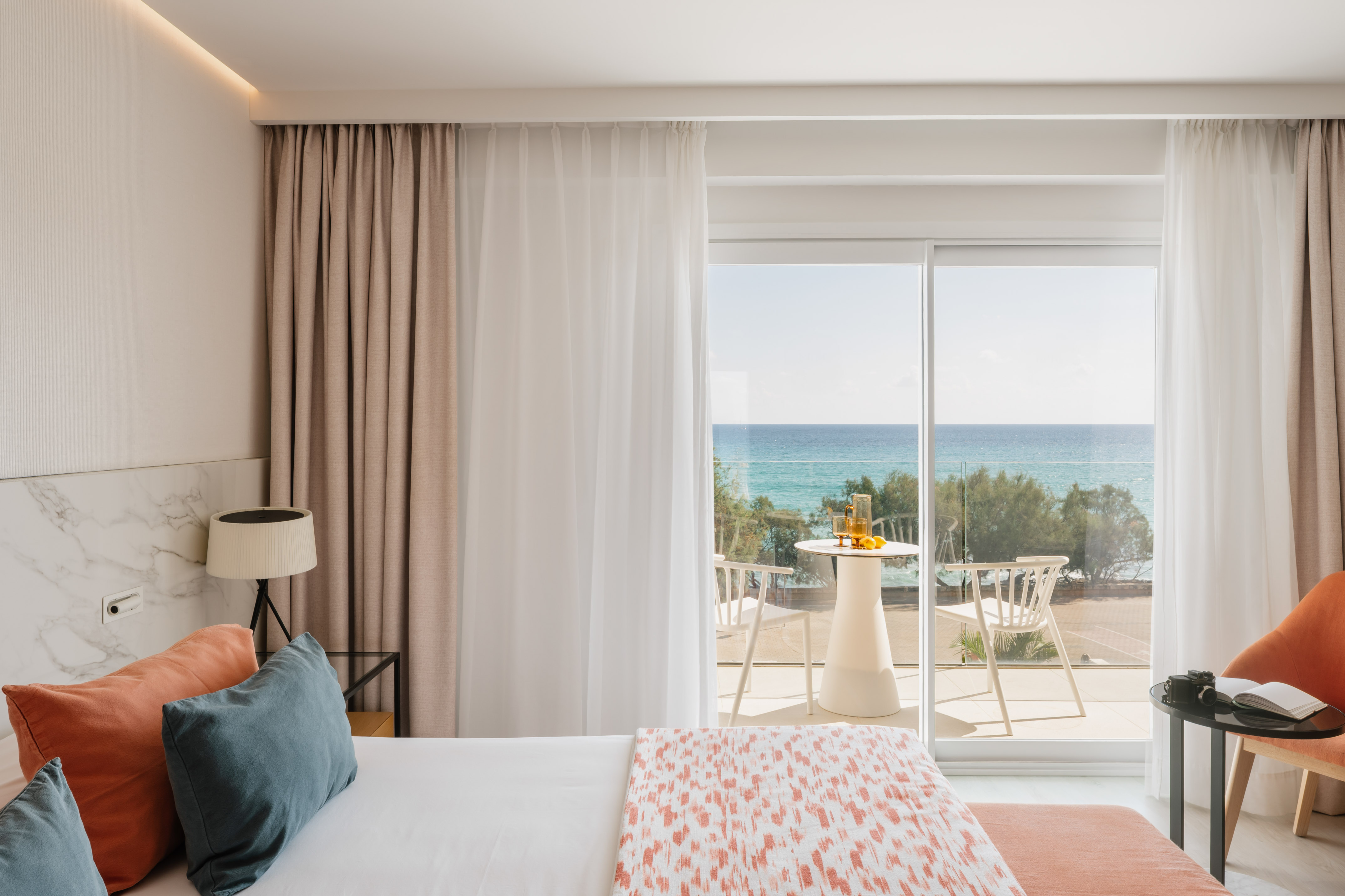 a bedroom with a view of the ocean