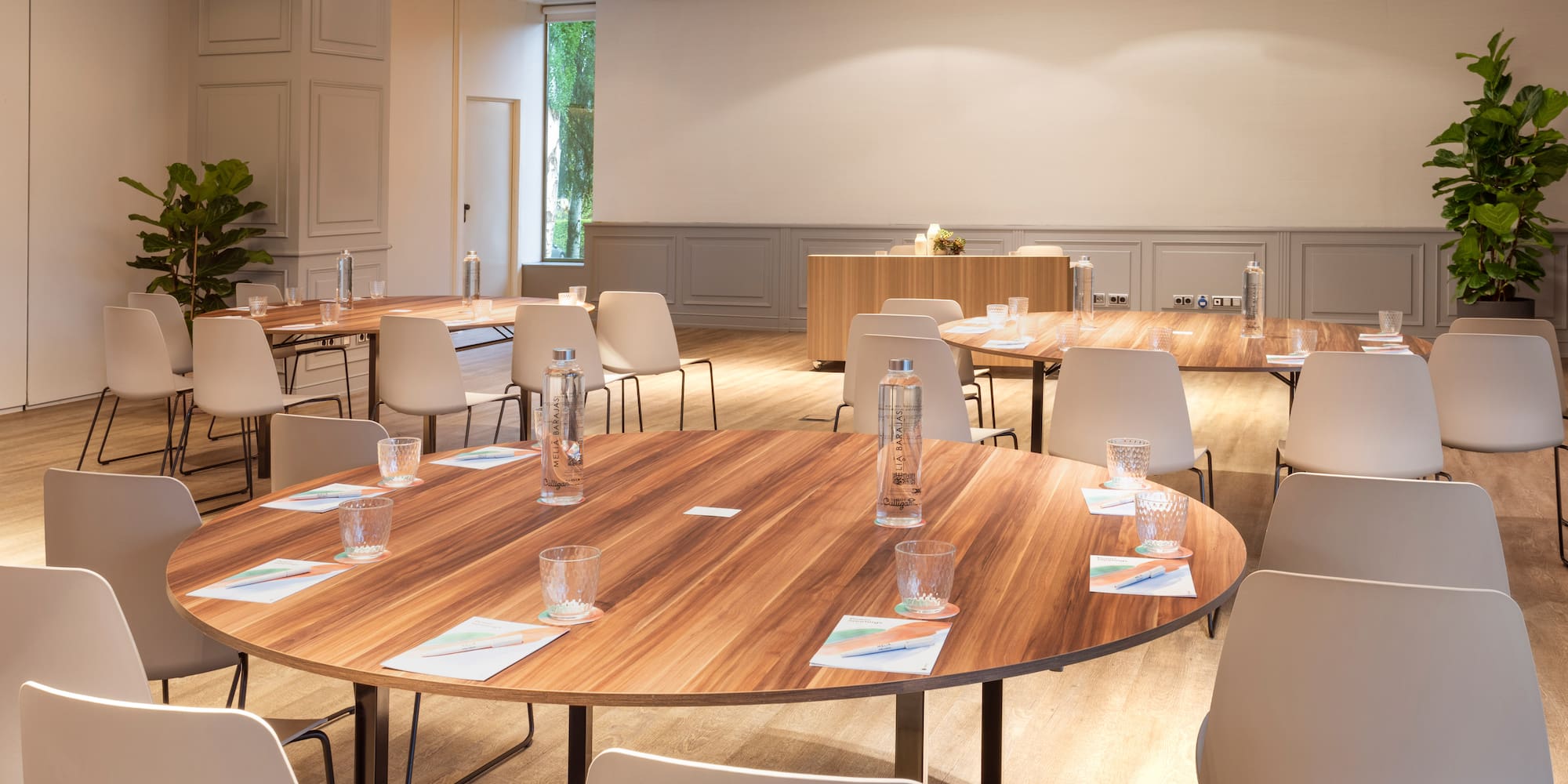 a room with a round table and chairs