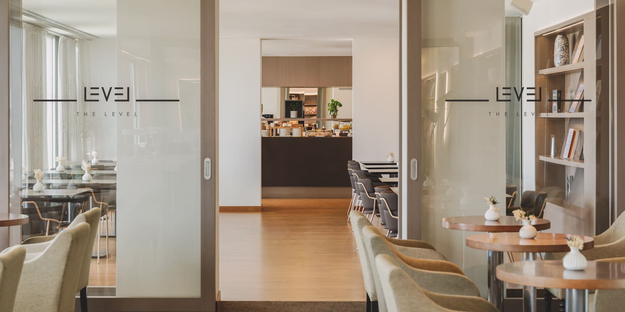 "The Level" hotel lounge, glass doors to buffet, comfortable seating.