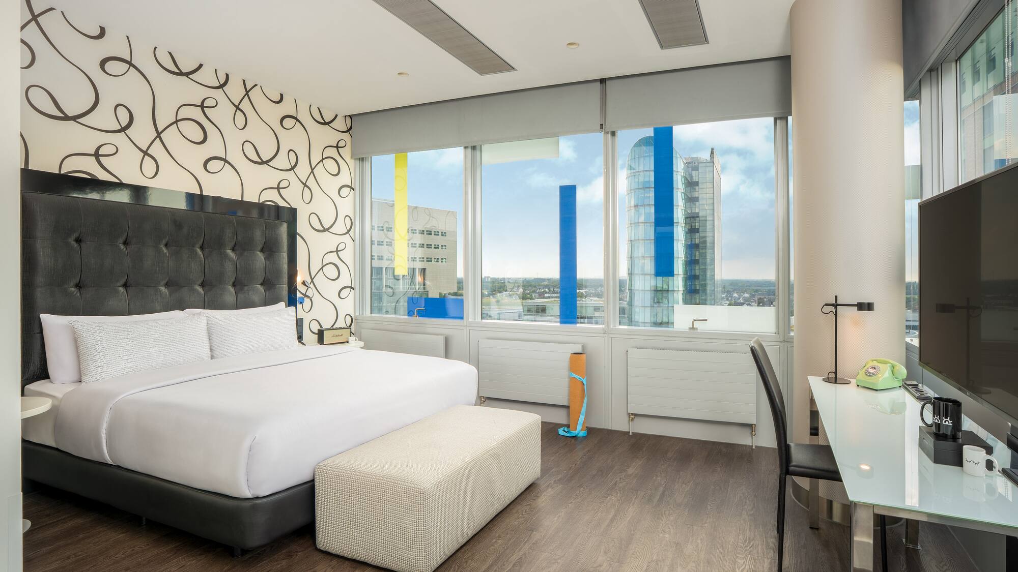 a bedroom with a large bed and a desk