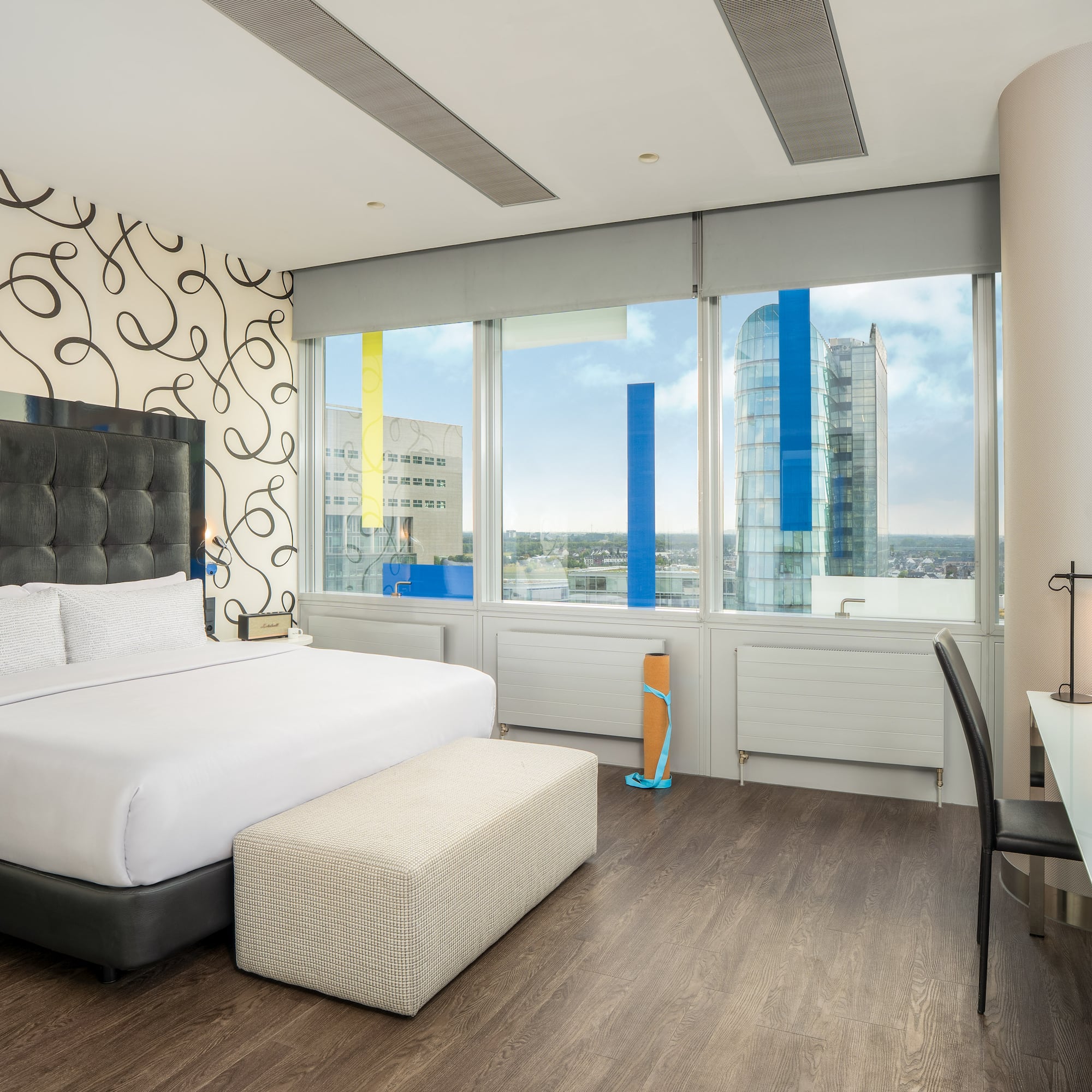 a bedroom with a large bed and a desk