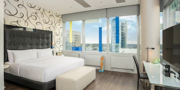 a bedroom with a large bed and a desk