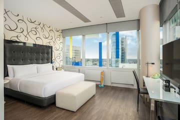 a bedroom with a large bed and a desk