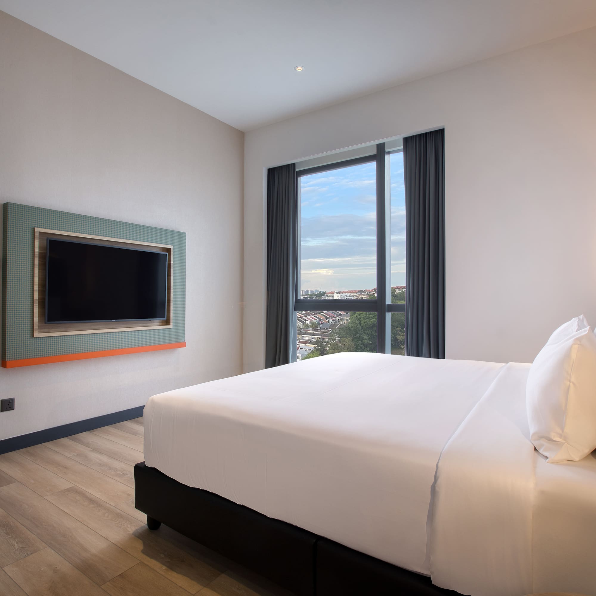 a room with a bed and a television