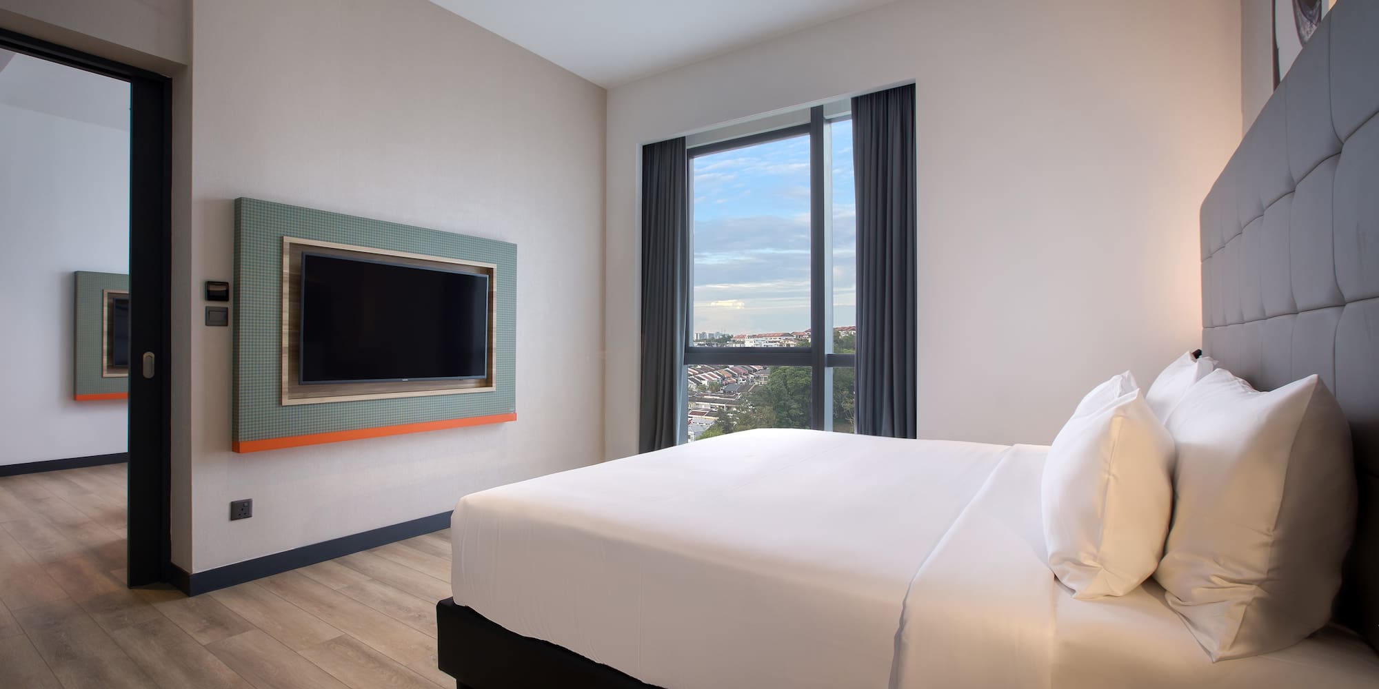 a room with a bed and a television