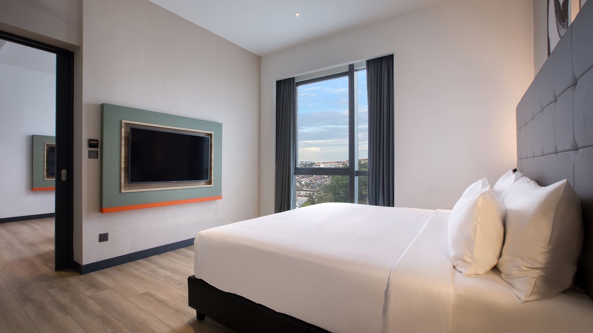 a room with a bed and a television