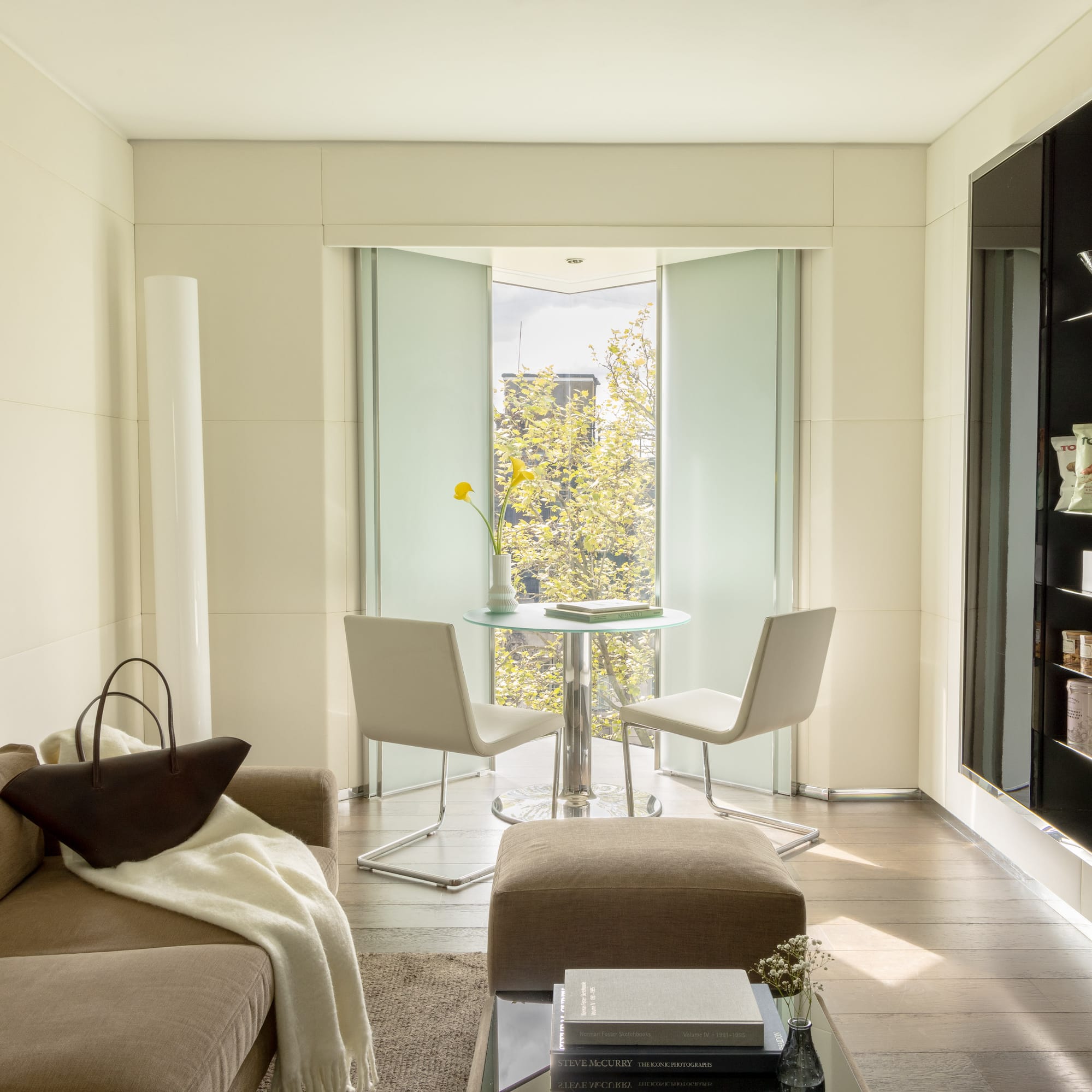 a living room with a table and chairs
