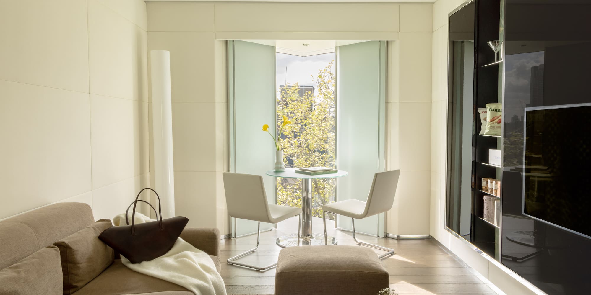 a living room with a table and chairs