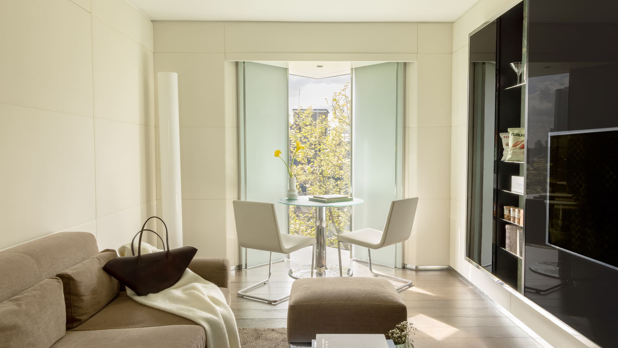a living room with a table and chairs