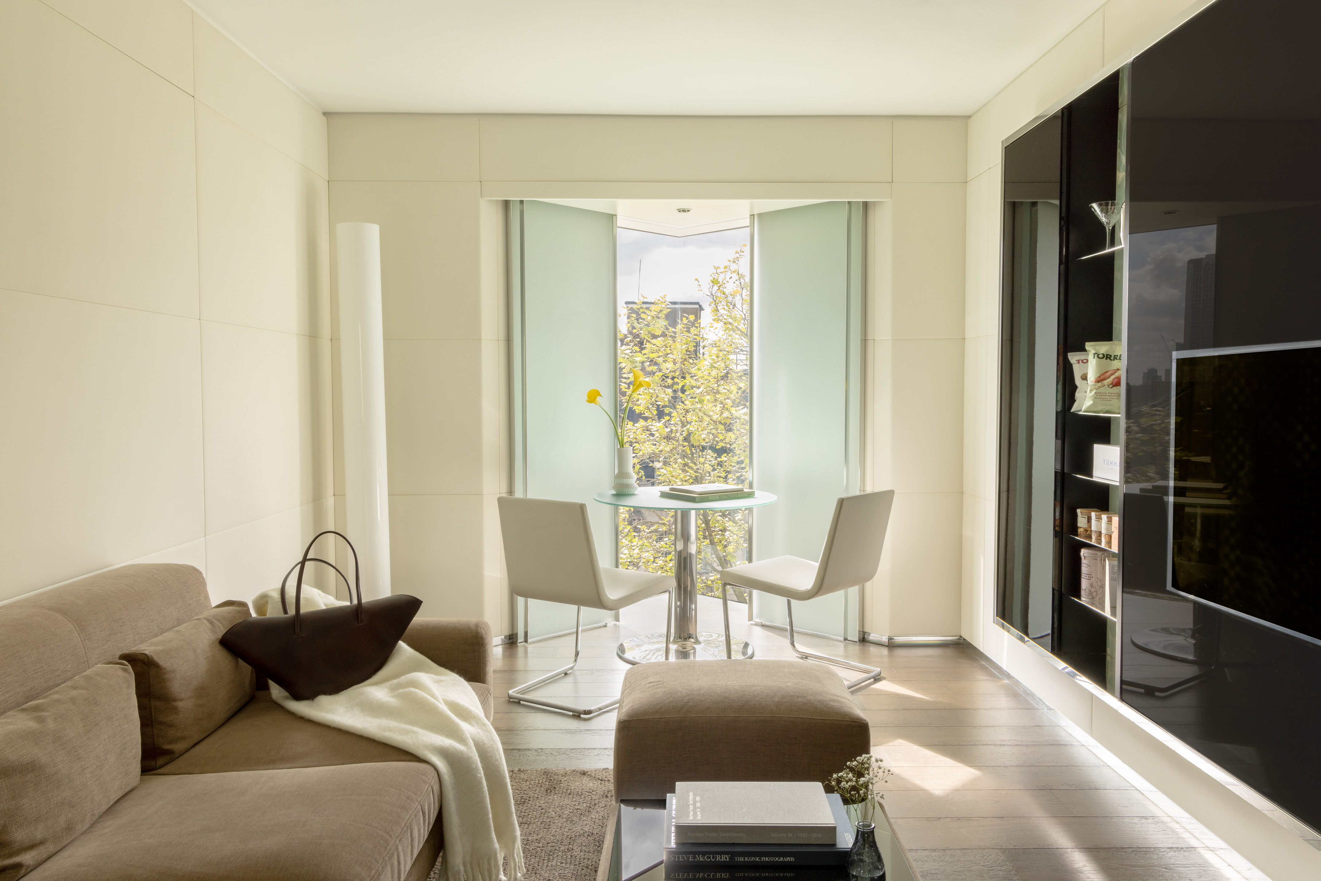 a living room with a table and chairs