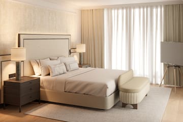 a bed with a bench in a room