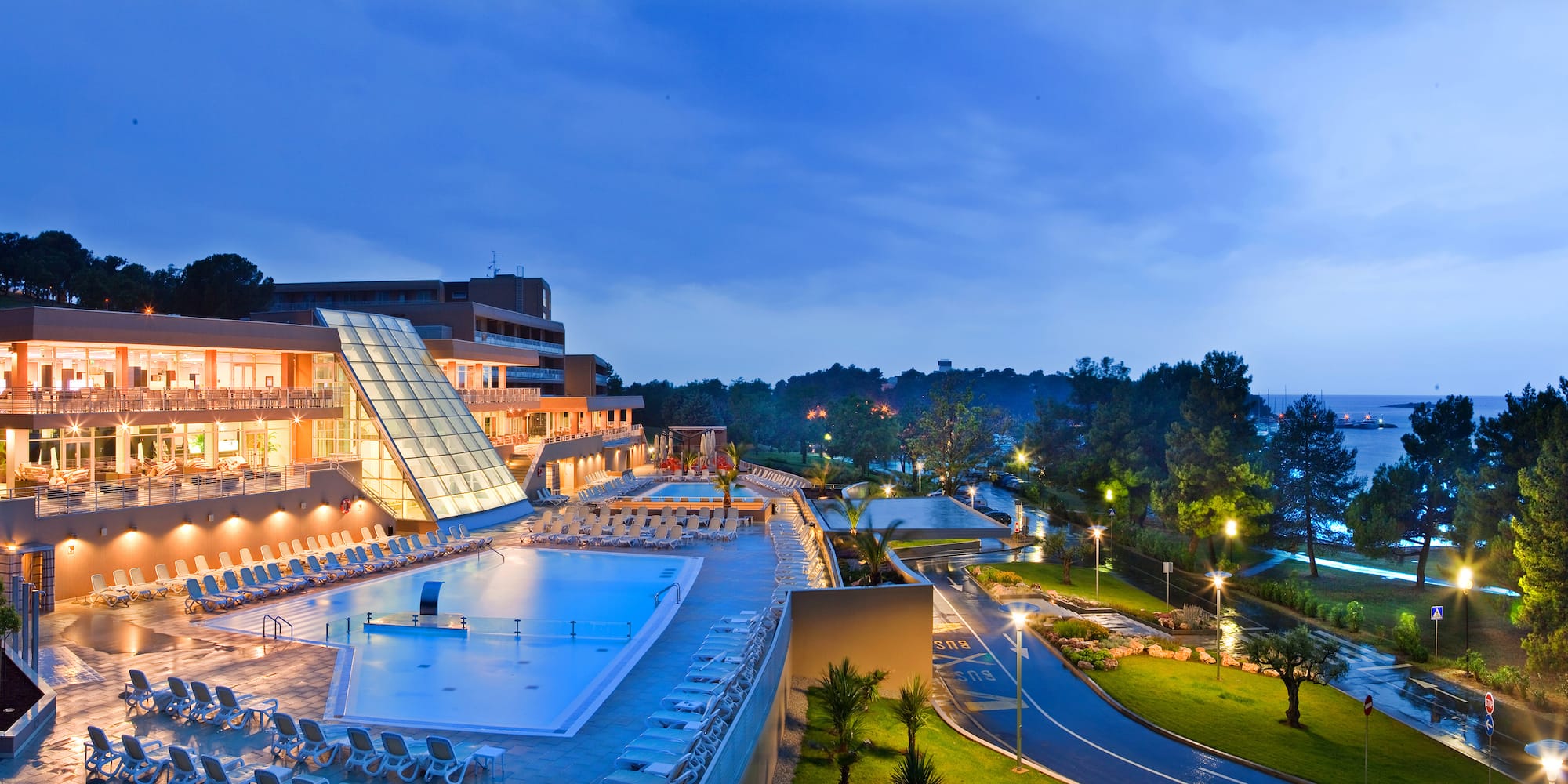 a pool and a building with a glass roof