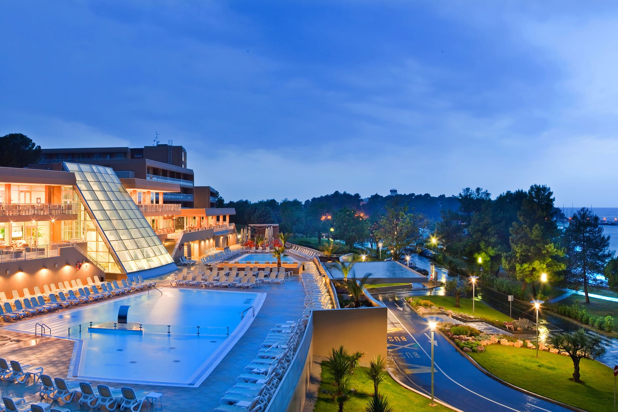 a pool and a building with a glass roof