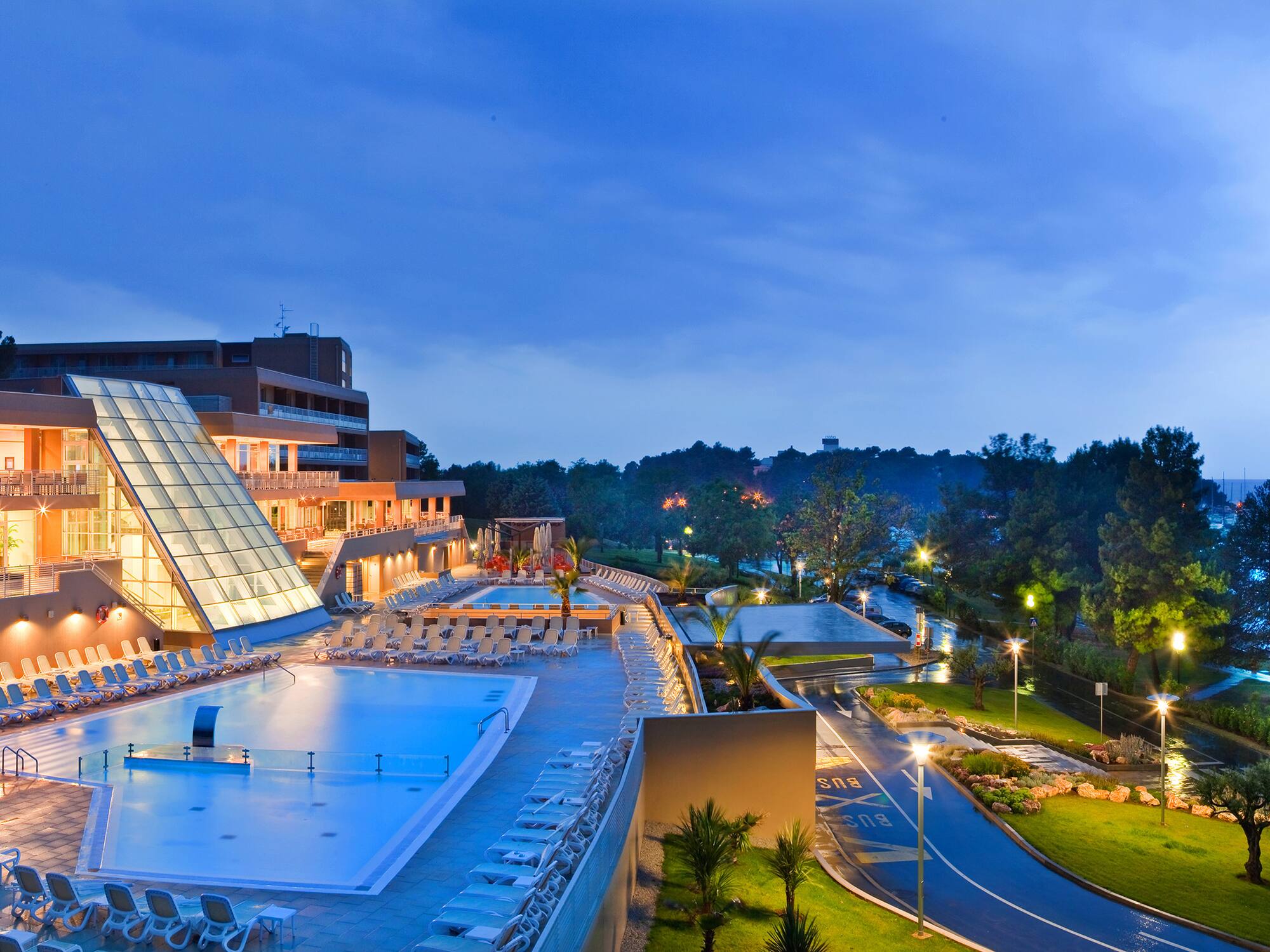 a pool and a building with a glass roof