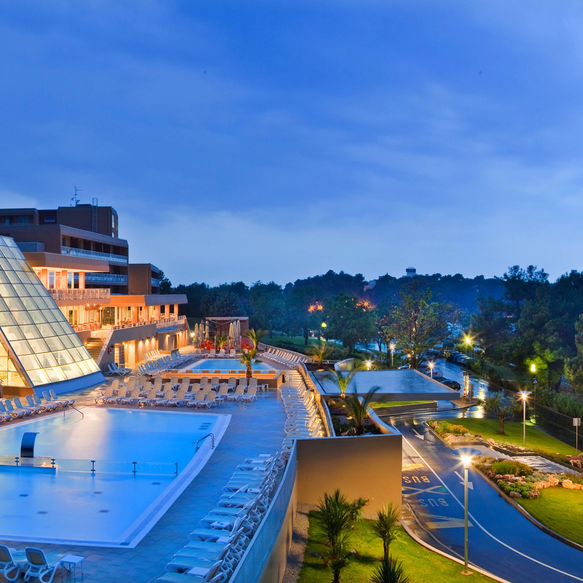 a pool and a building with a glass roof