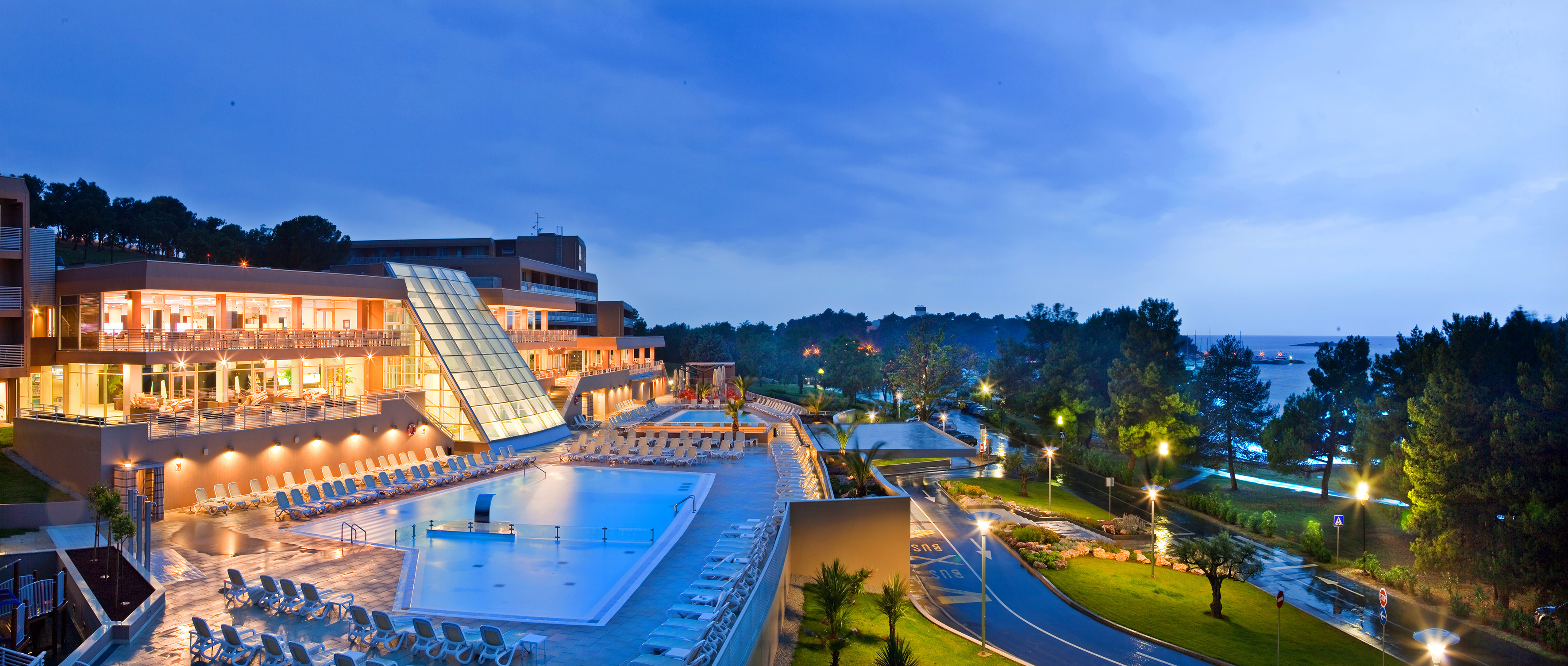 a pool and a building with a glass roof