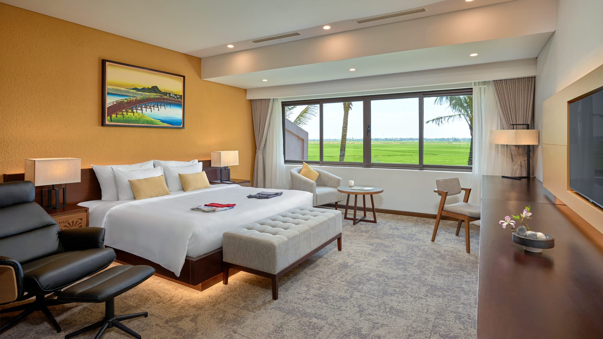 a room with a bed and chairs