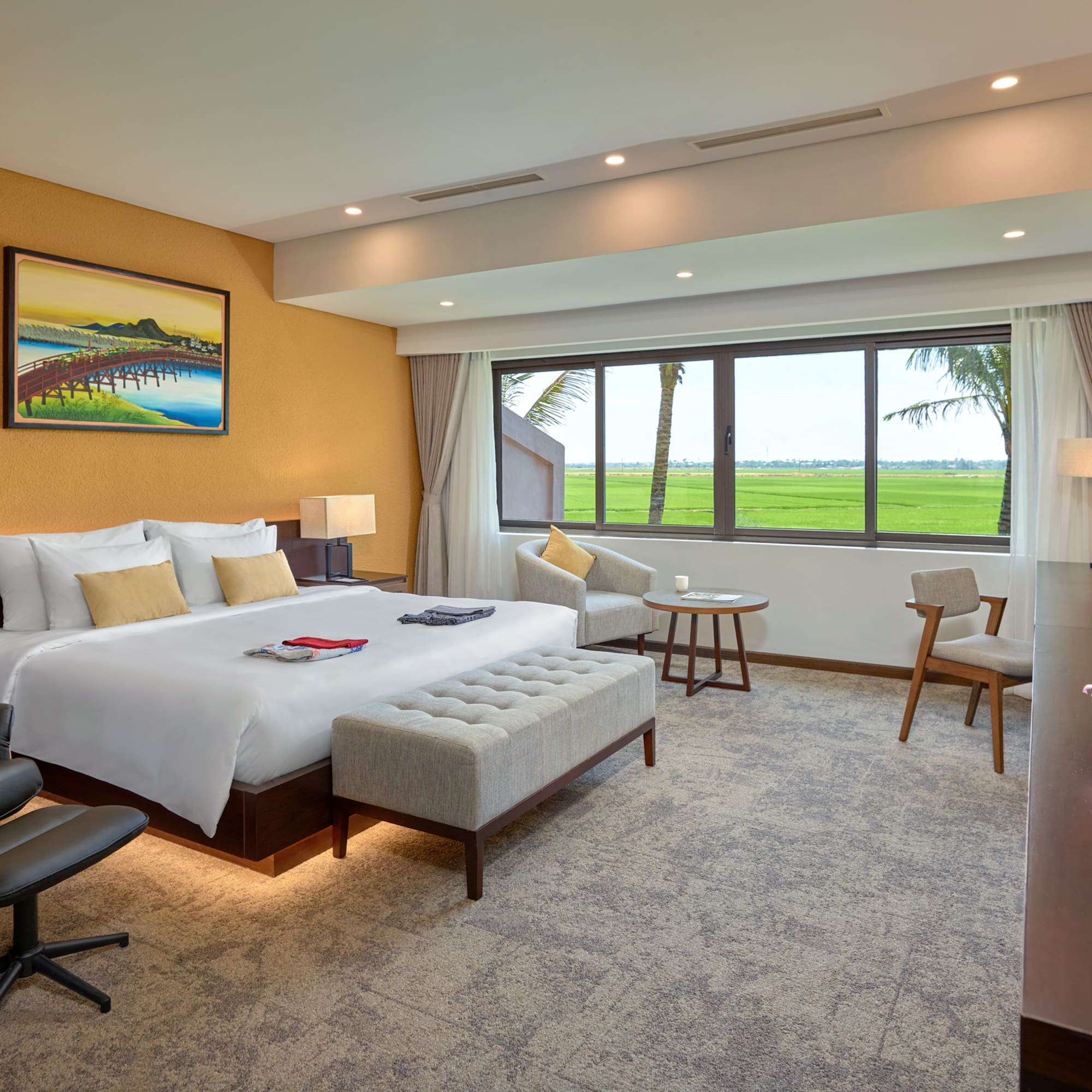 a room with a bed and chairs