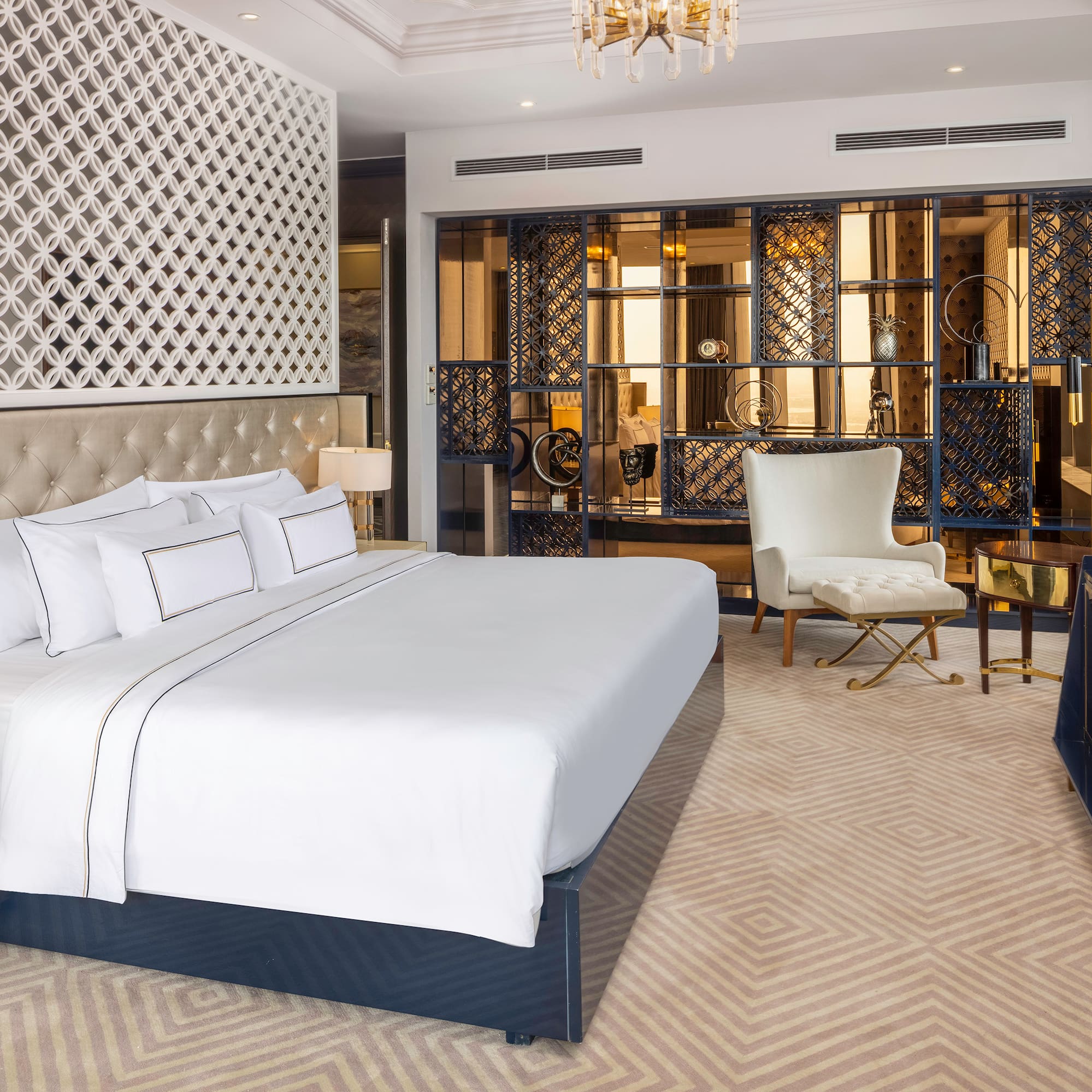 a bedroom with a large bed and a chair