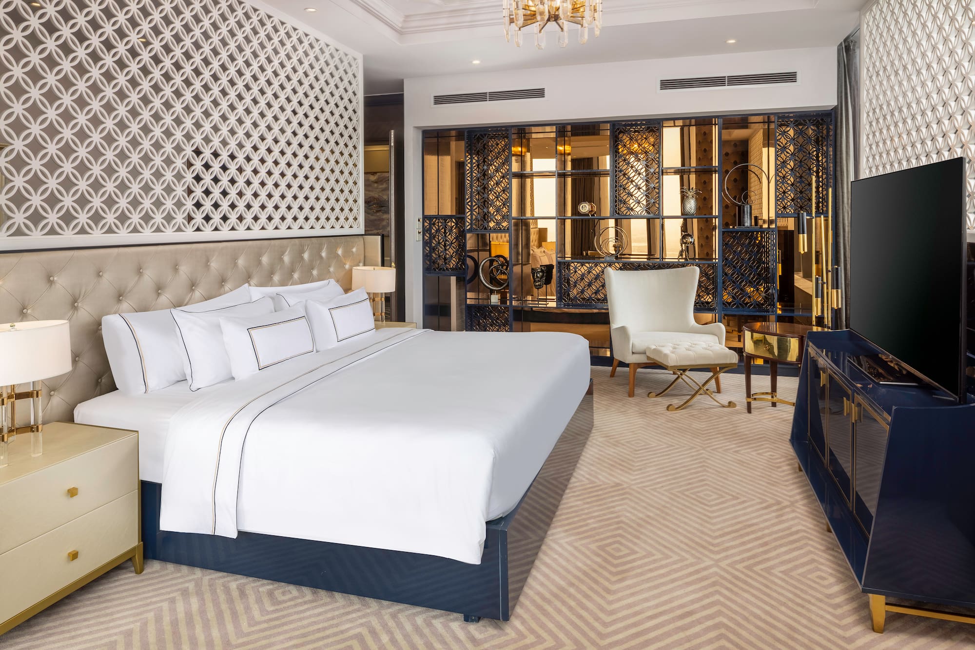 a bedroom with a large bed and a chair