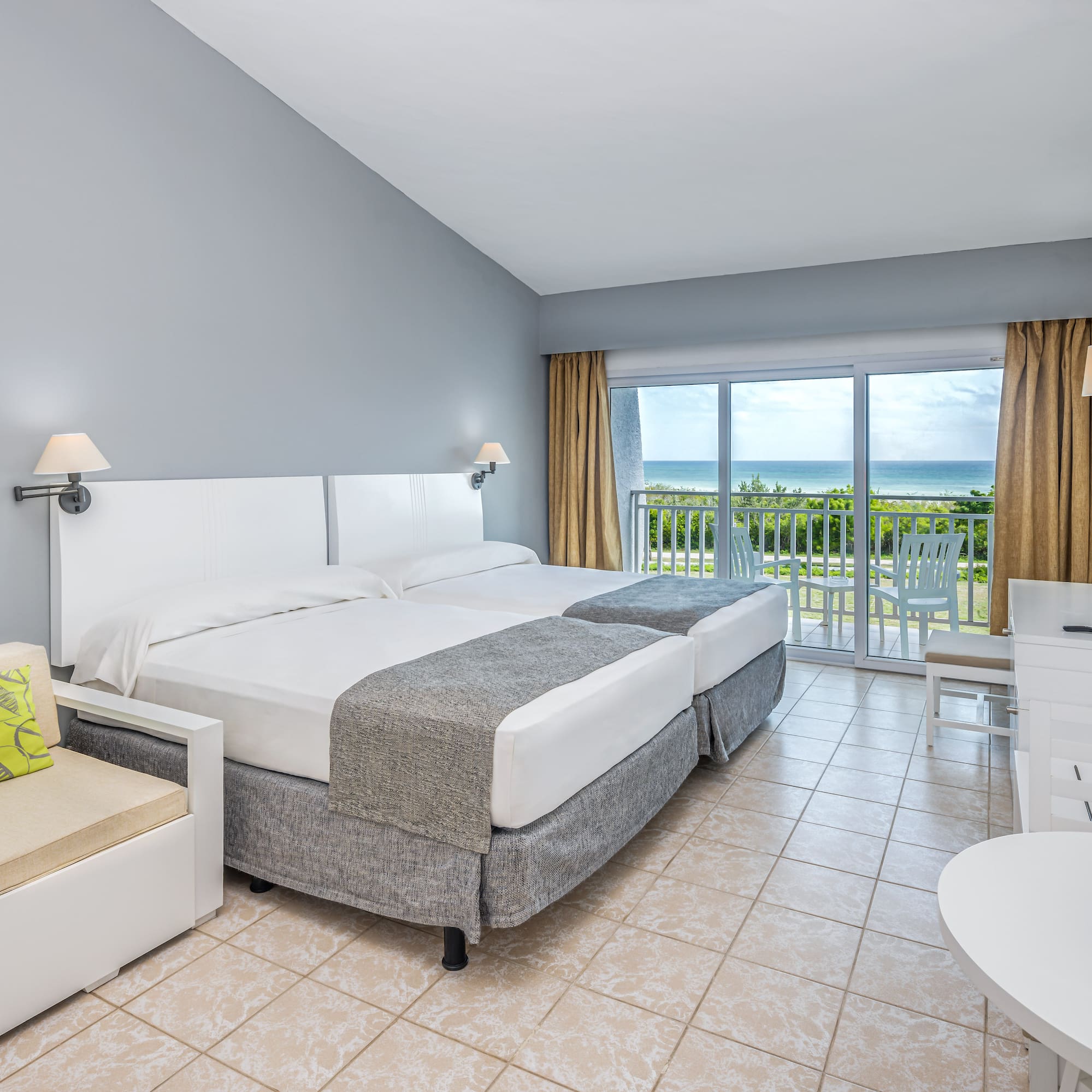 a room with a bed and a chair and a table