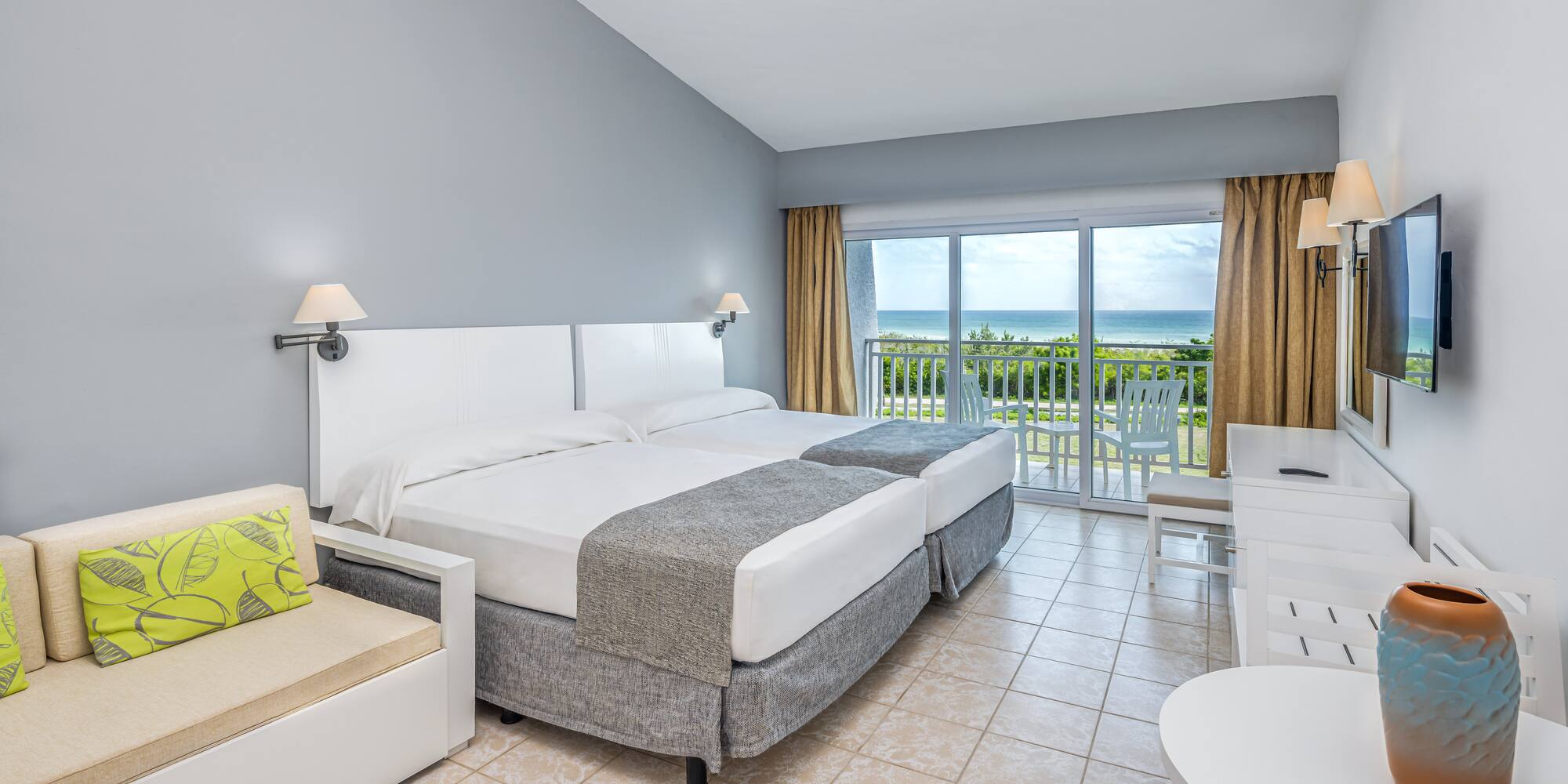 a room with a bed and a chair and a table